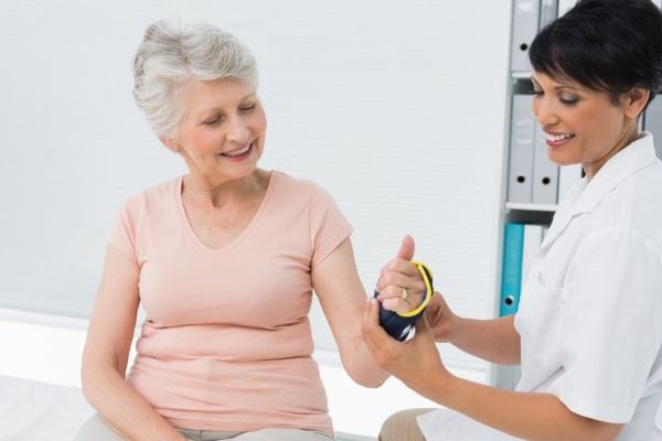 nurse putting hand brace on patient