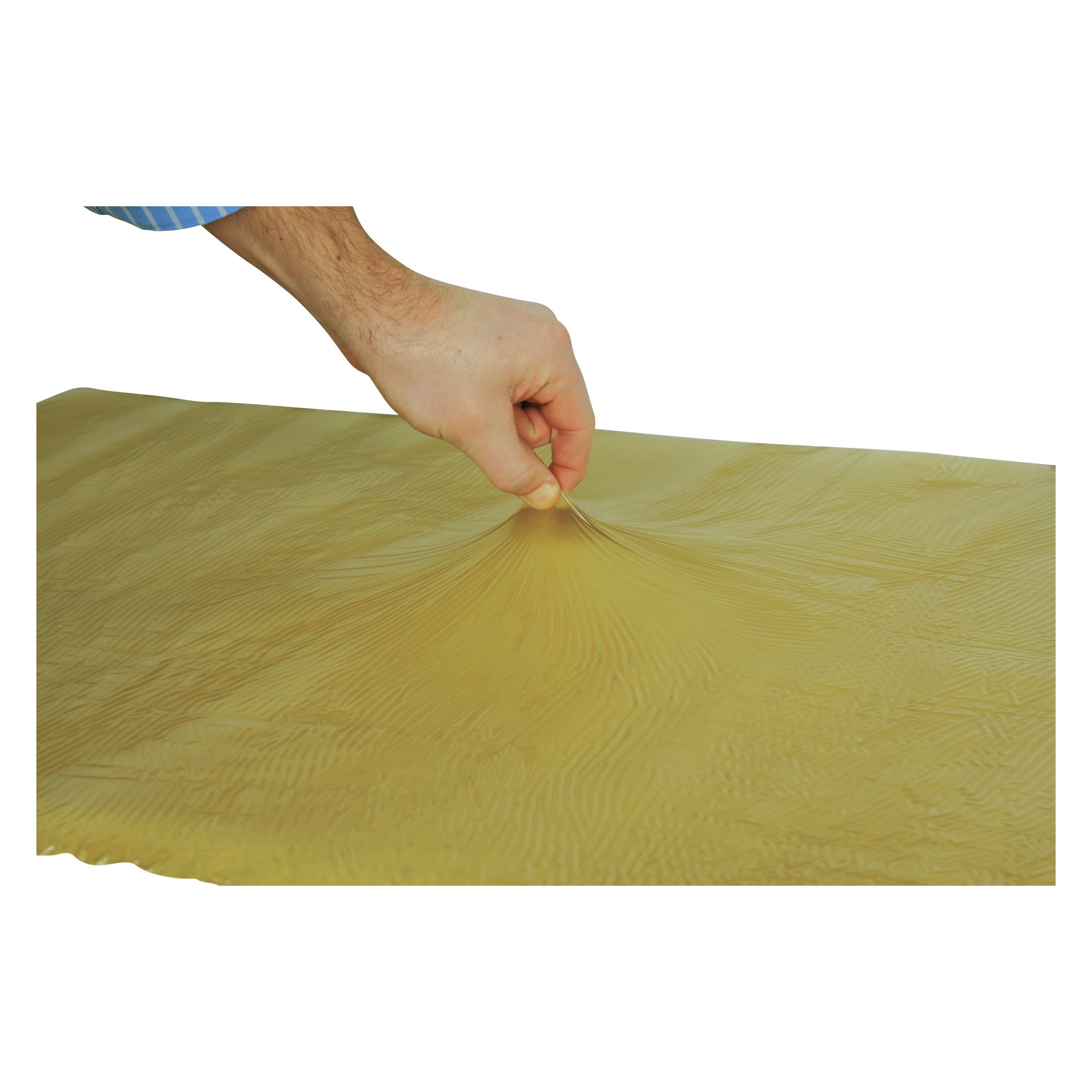 A hand pinching the surface of the AliMed T-Gel Mattress Topper, displaying its stretchy and textured yellow material.