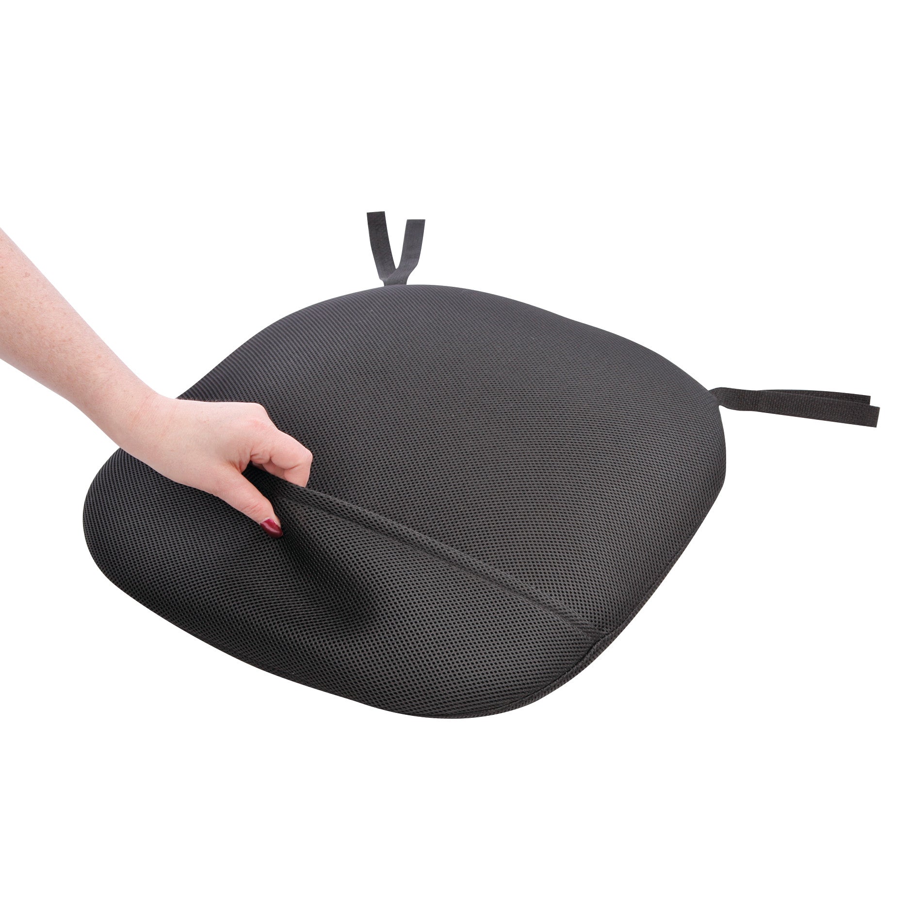 A hand lifts the BodyBilt Stratta Mesh Seat Cushion, showcasing its flexible, textured black surface with attached straps.