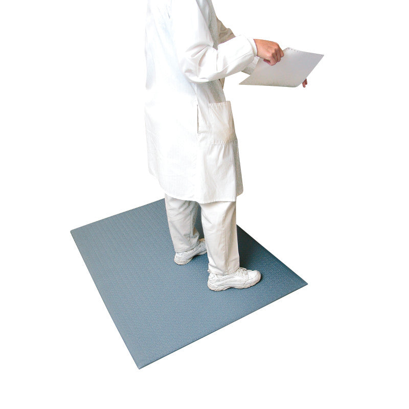 A person stands on a Comfort-King Antimicrobial Anti-Fatigue Mat while holding papers. The mat is gray and textured.