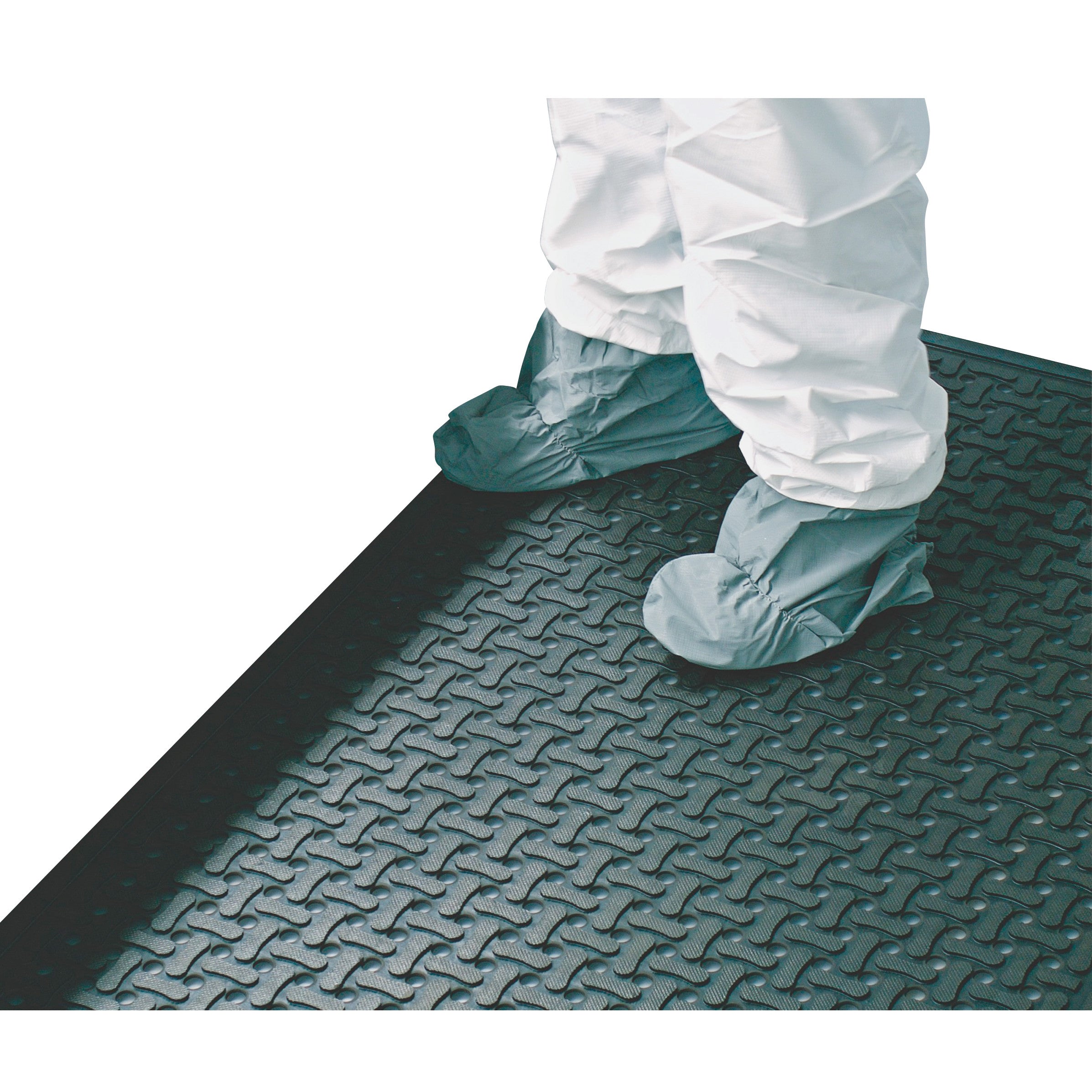 Person stands on a Comfort Flow Anti-Fatigue Mat, wearing protective suit and shoe covers. The mat has a textured surface.