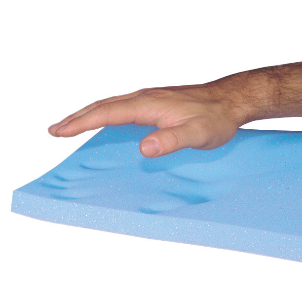A hand presses into a blue AliMed T-Foam Uncovered Wheelchair Cushion, showing finger indentations in the foam.