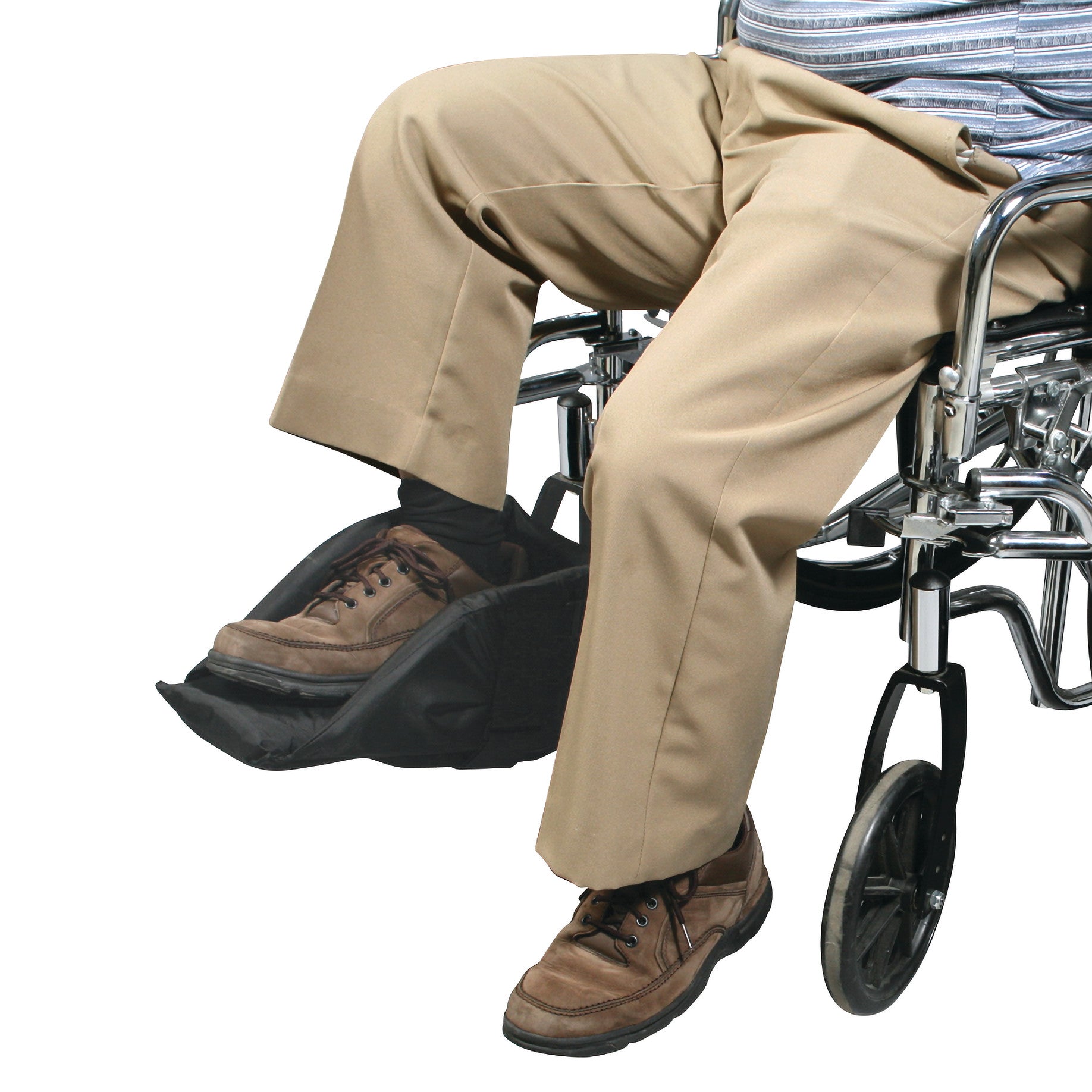 A person sits in a wheelchair, using the SkiL-Care Swing-Away Foot Support. It cradles the feet and adjusts for comfort.