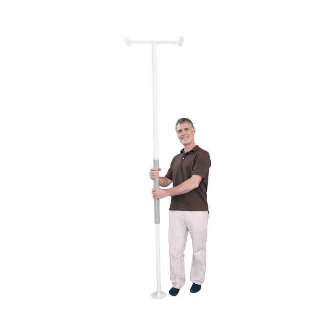 A man stands holding a Security Pole, a tall white pole with a supportive handle, designed to aid balance and mobility.