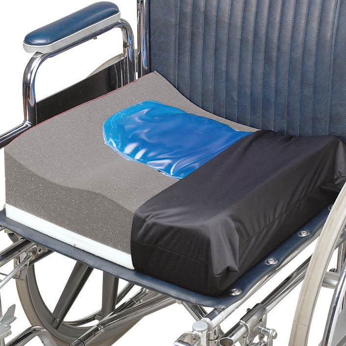 A SkiL-Care Contour Wheelchair Cushion with a blue gel section and a black cover is placed on a metal wheelchair seat.