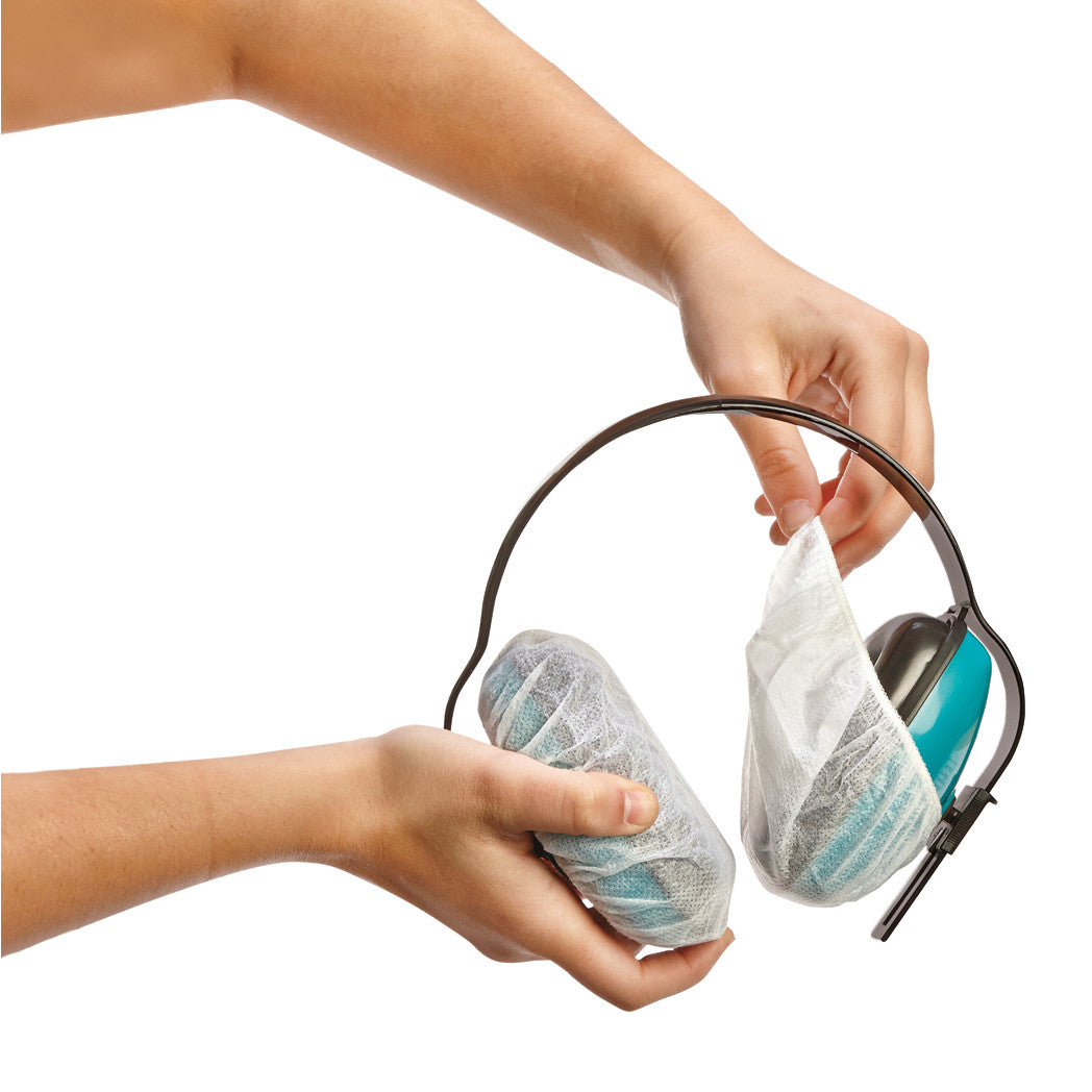 Hands placing AliMed Sanitary Headset Covers over blue earmuffs, showing protective hygiene use.