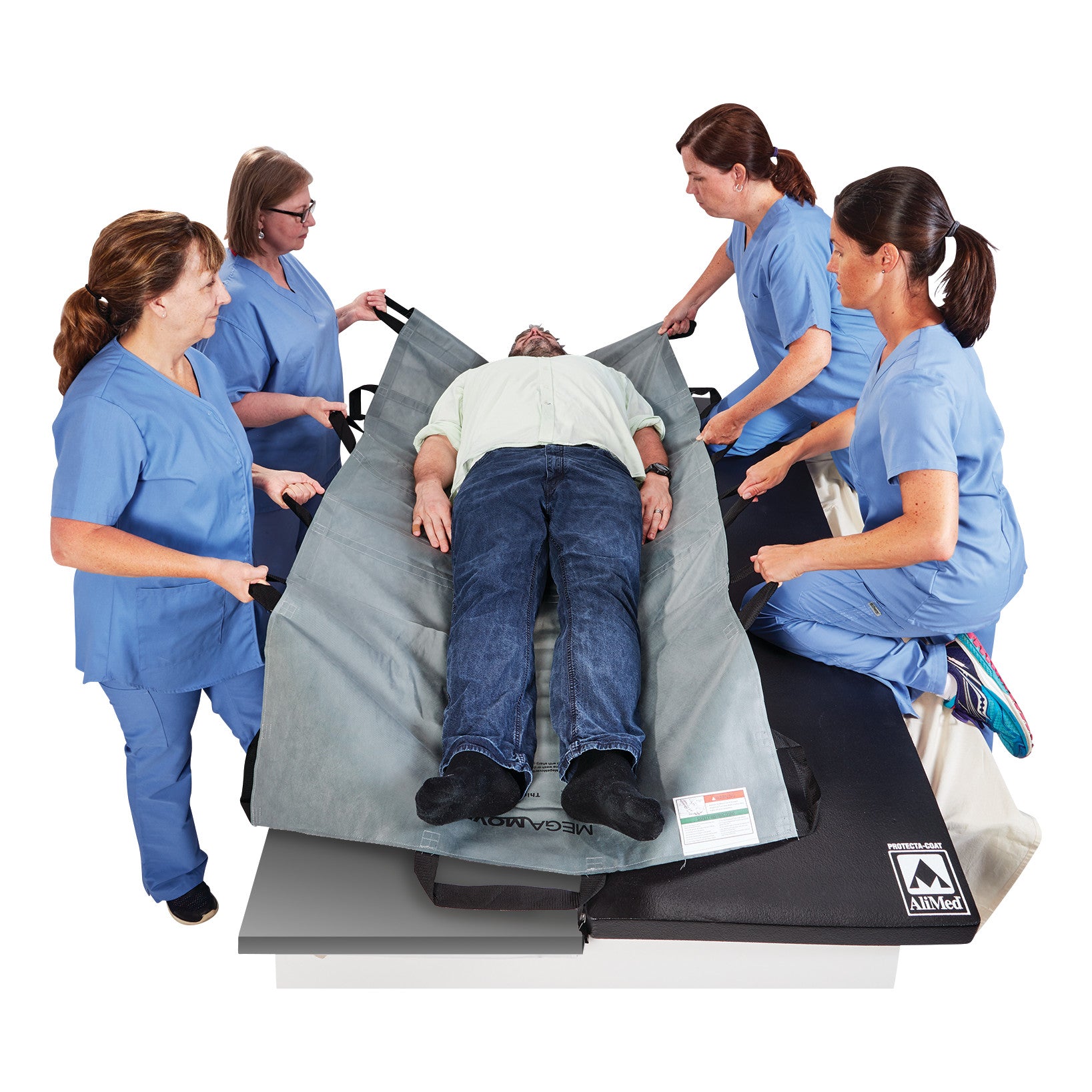 Four healthcare workers in blue uniforms lift a patient using the Graham Medical MegaMover Plus Transport Unit.