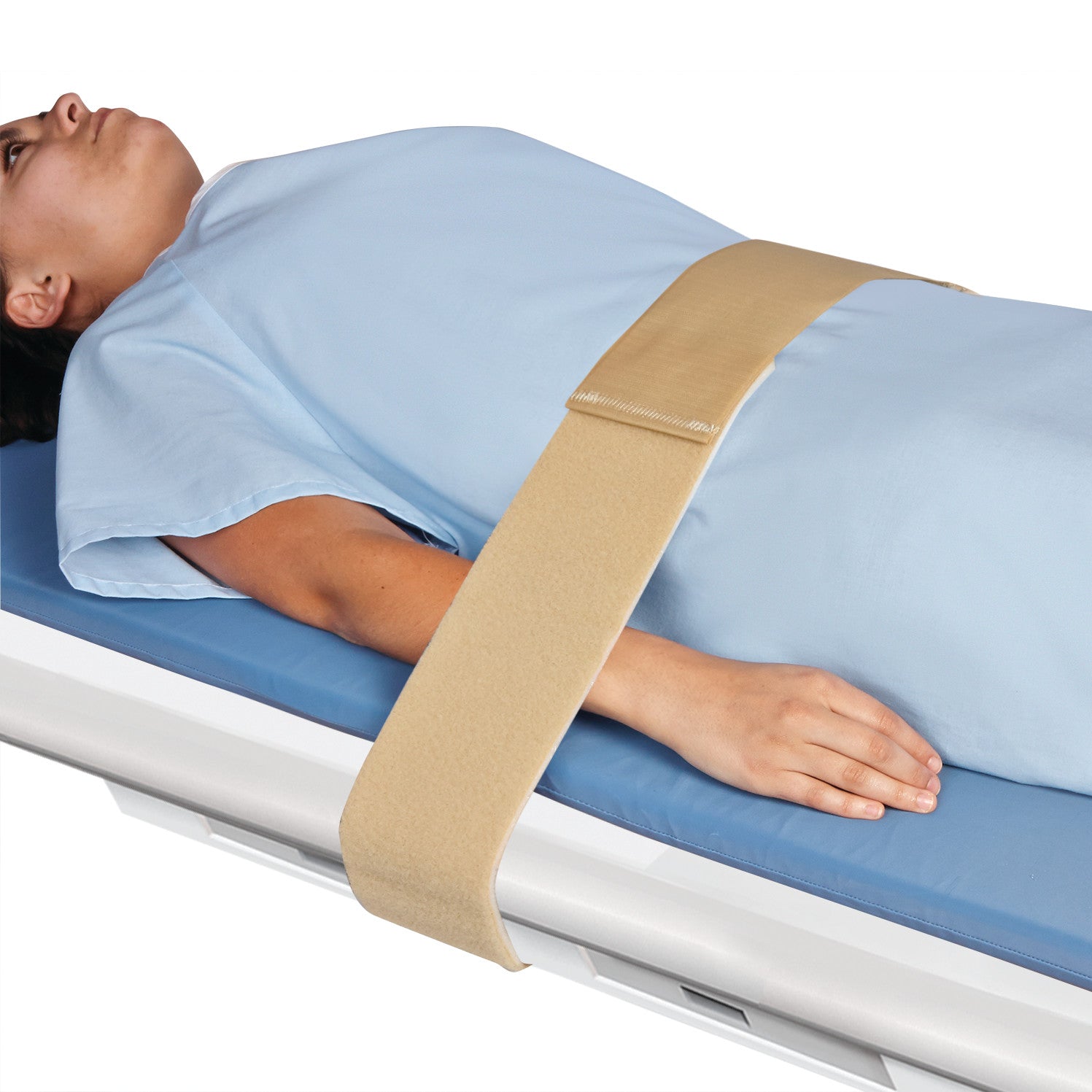 A person lies on a table with the AliMed Universal Econo-Strap securing their body, wearing a light blue gown.