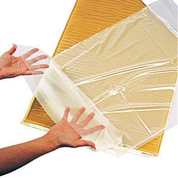 Hands hold the AliMed Disposable Fitted Sheet Style Cover for Gel Surface Overlay, a clear protective covering for medical use.