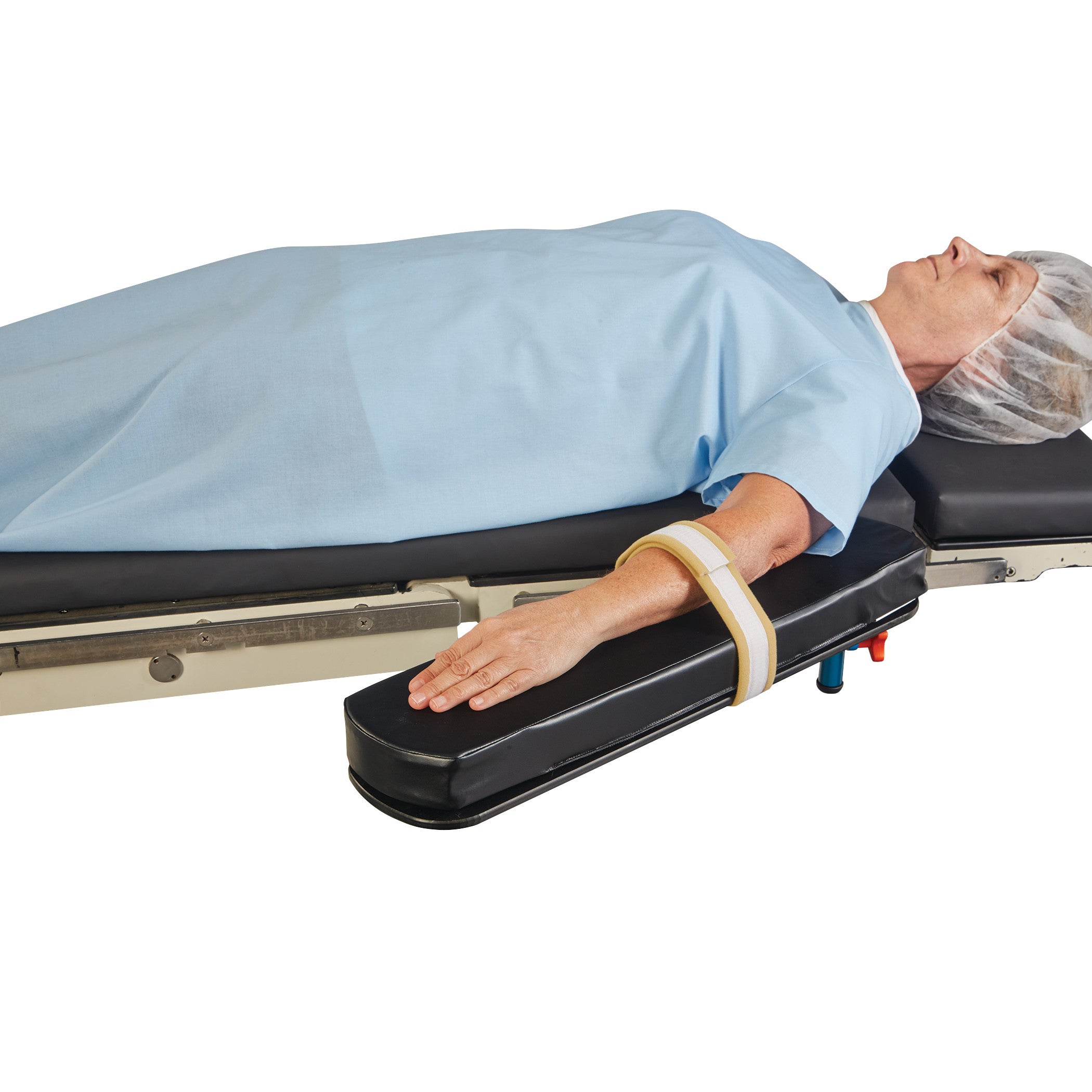 A patient lies on a surgical table with an AliMed AliStrap Soft Precut Patient Safety Strap securing their arm.