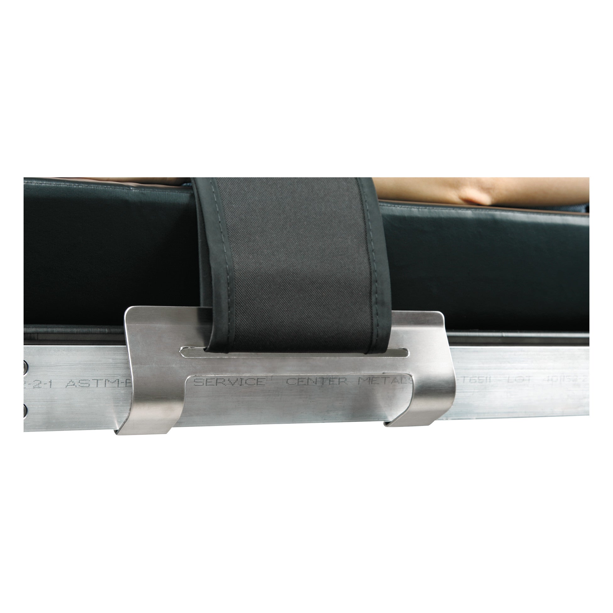 The AliMed Grabber Bracket secures a strap over the edge of a metal surface, likely for use in a medical or patient transport setting.