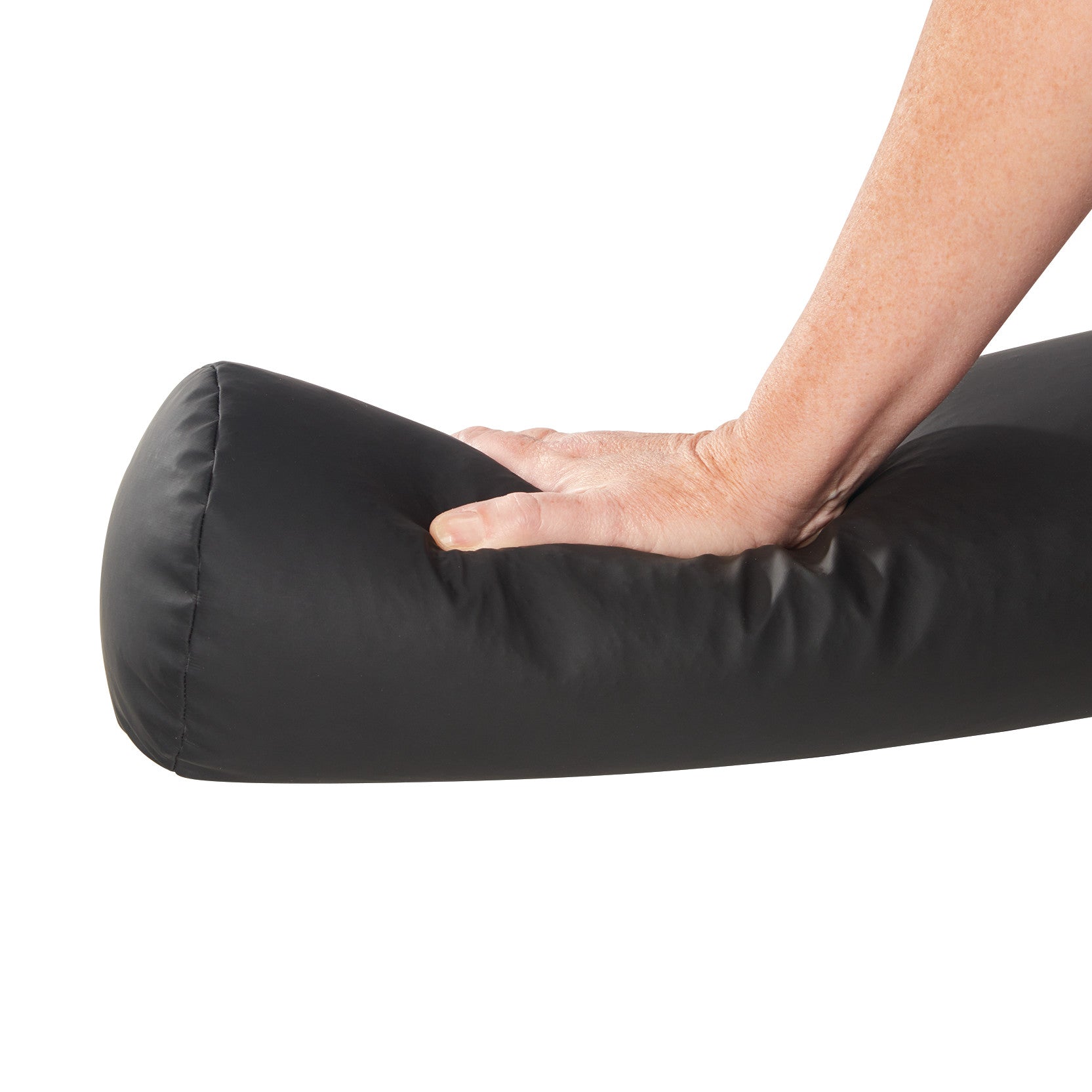 A hand presses on the AliMed ComPly Chest Roll Positioner, a black cylindrical cushion used for patient support.