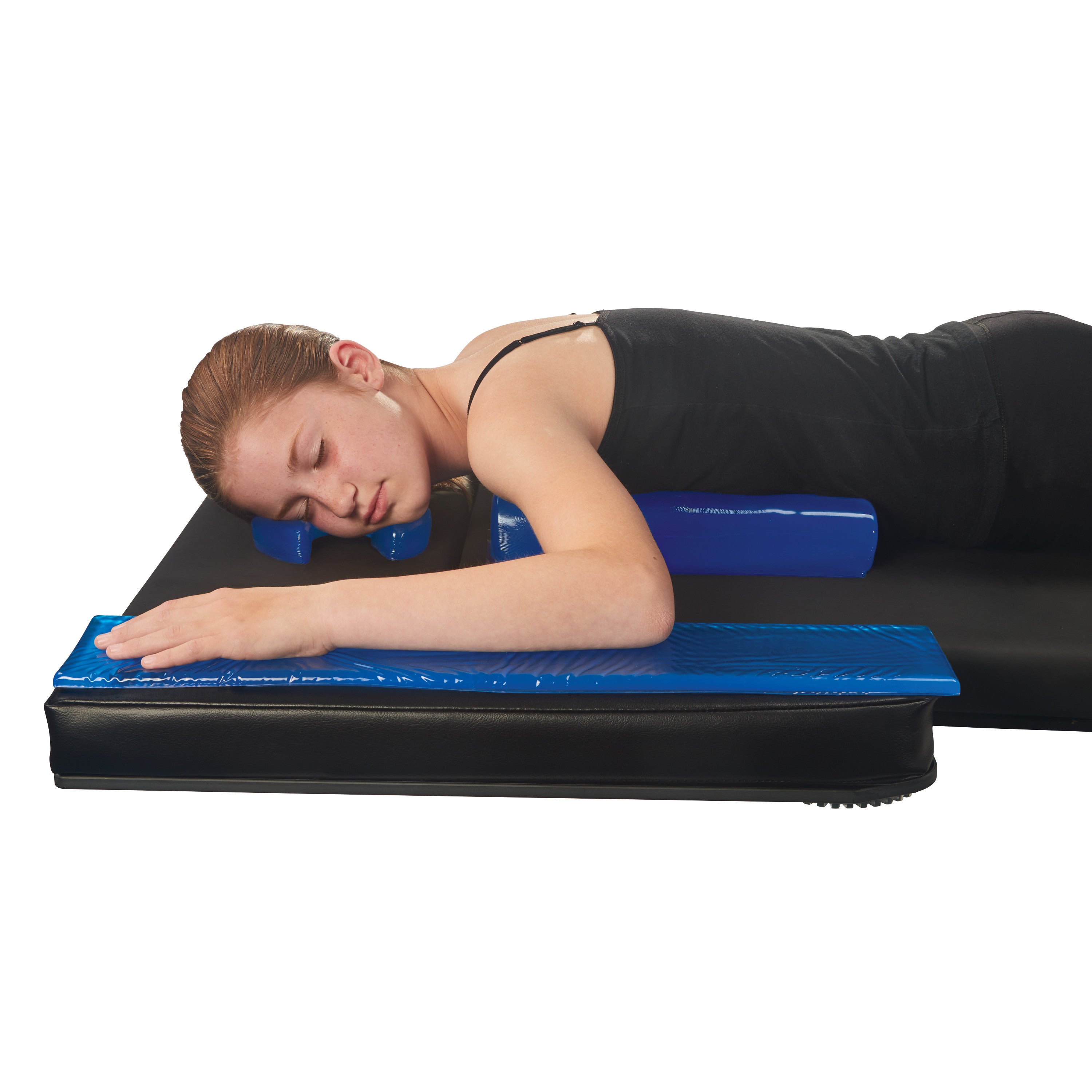 A person lies face down on an AliMed AliBlue Gel Chest Roll, with arms extended, on a black mat for support and comfort.