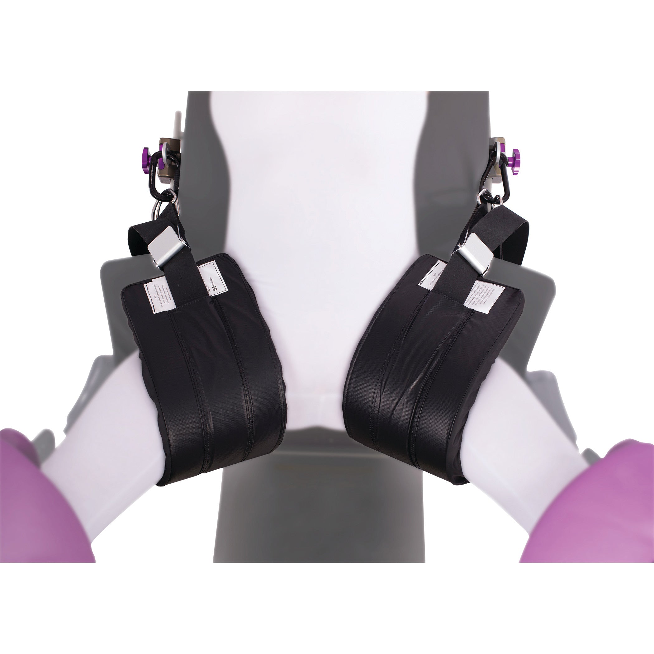 Close-up of KYRA Nissen Strap in use, securing the lower legs in a medical support system with black padded straps.