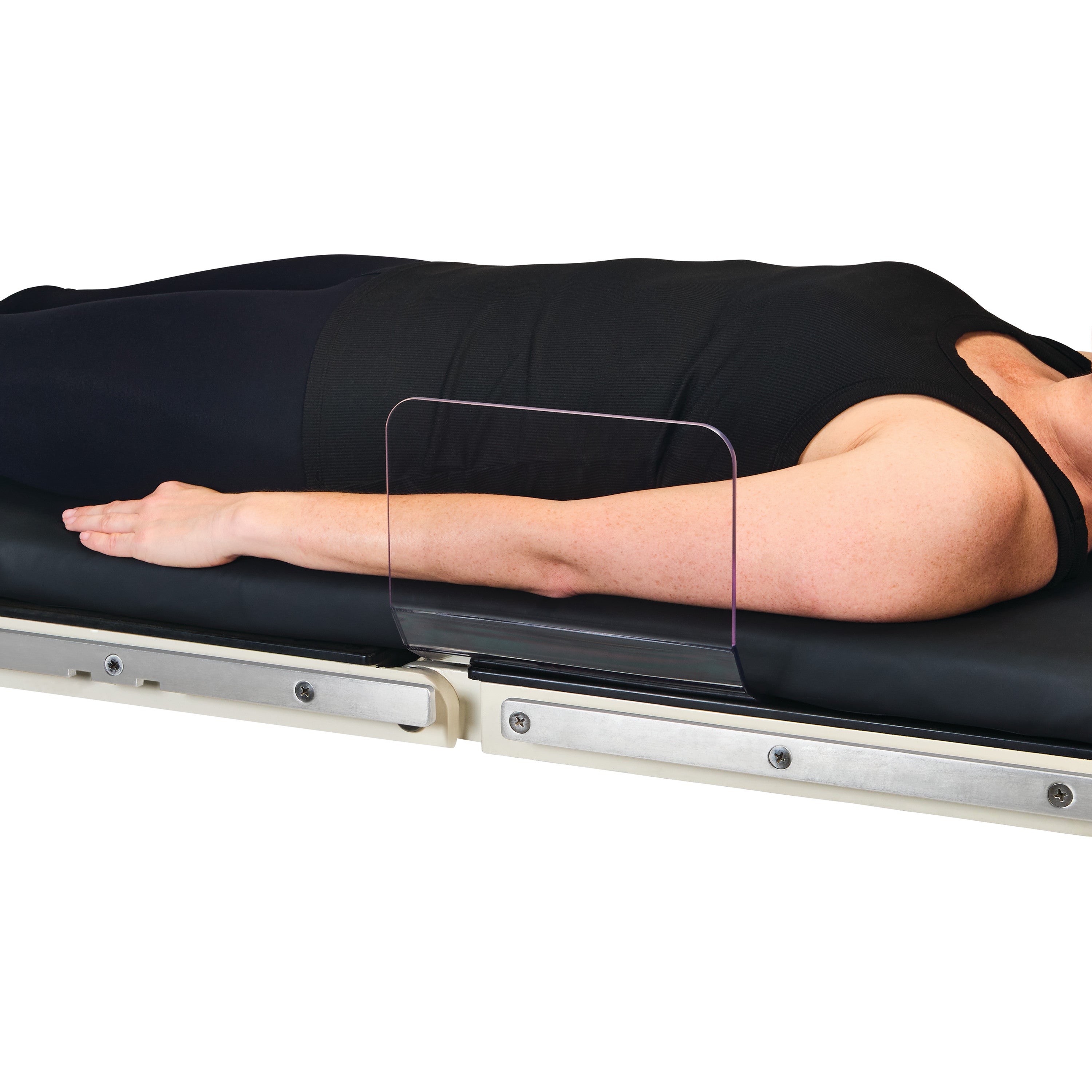 A person lies on a medical table using the AliMed Straight Toboggan Arm/Leg Guard to support their arm.