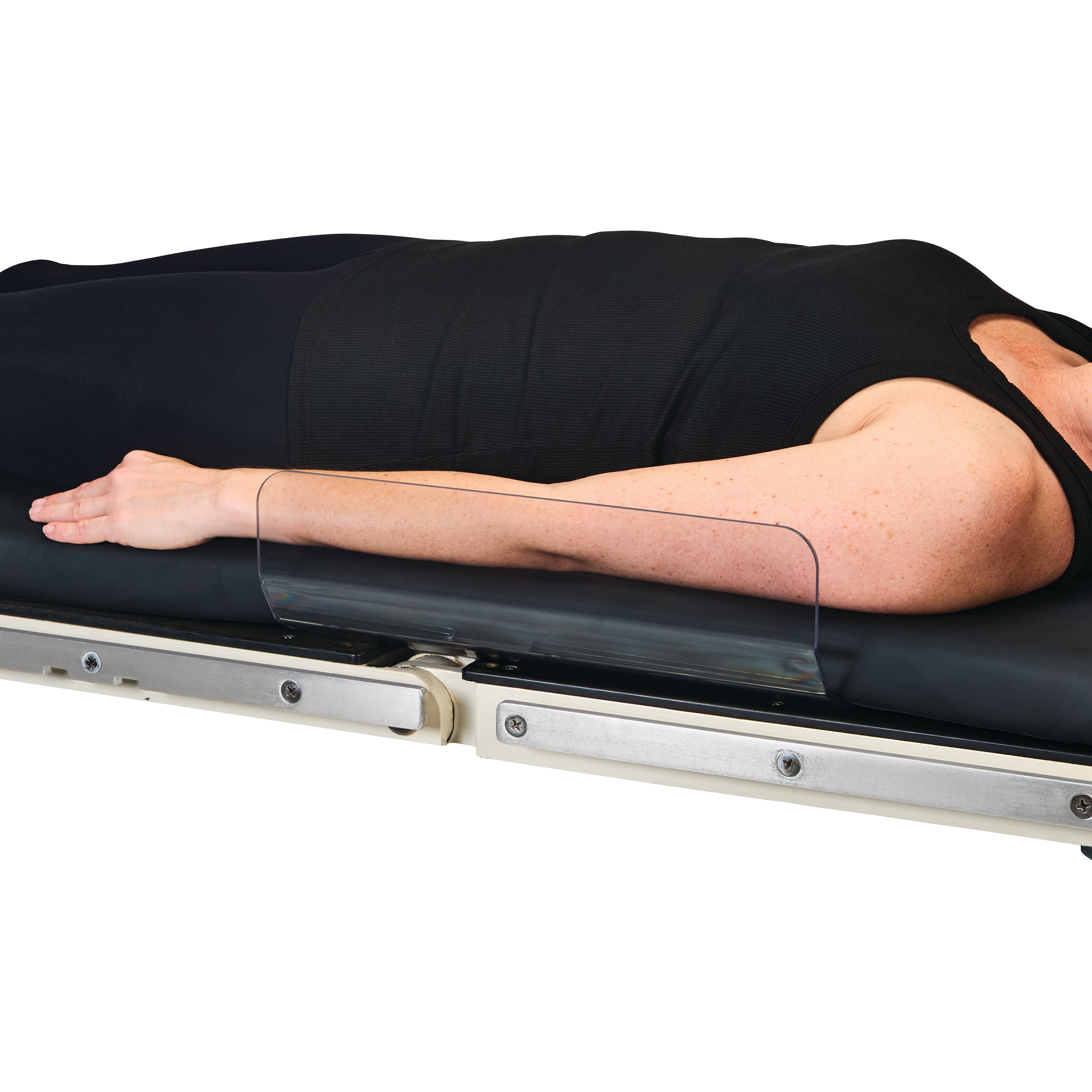 A patient lies on a table with an AliMed Low-Profile Toboggan Arm/Leg Guard securing the arm, shown in a side profile view.