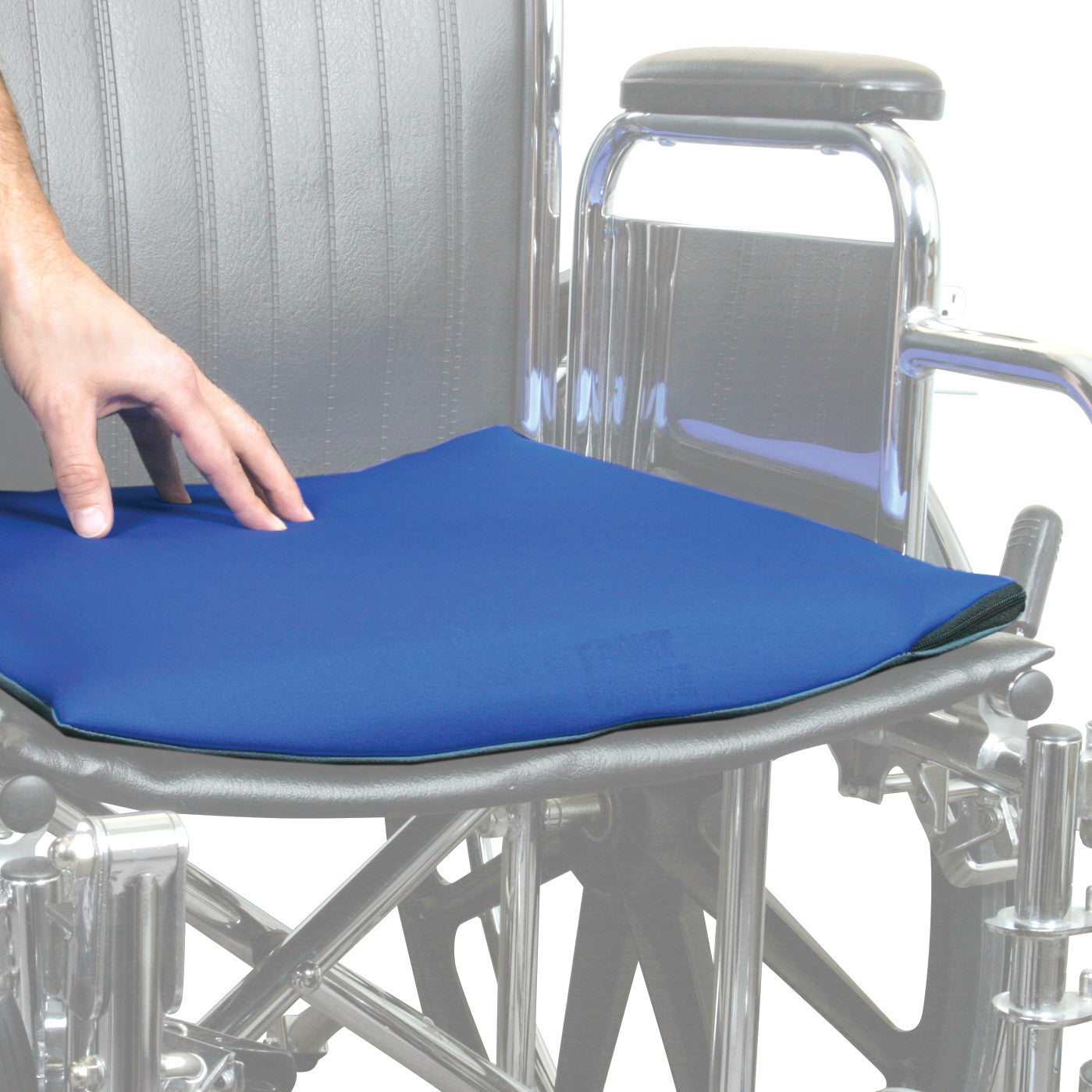 A hand adjusts the AliMed Stroke Wheelchair Cushion, which is blue, placed on a wheelchair seat.