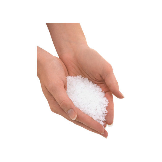 Hands holding white Therabath Paraffin Bath Beads Refill against a white background.