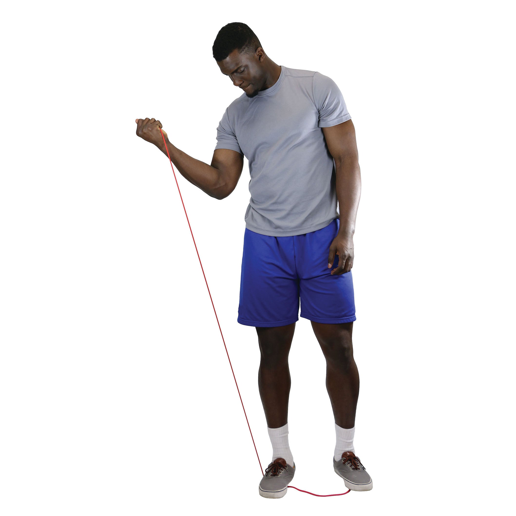 A man exercises with red CanDo Exercise Tubing, wearing a gray shirt, blue shorts, socks, and shoes on a white background.