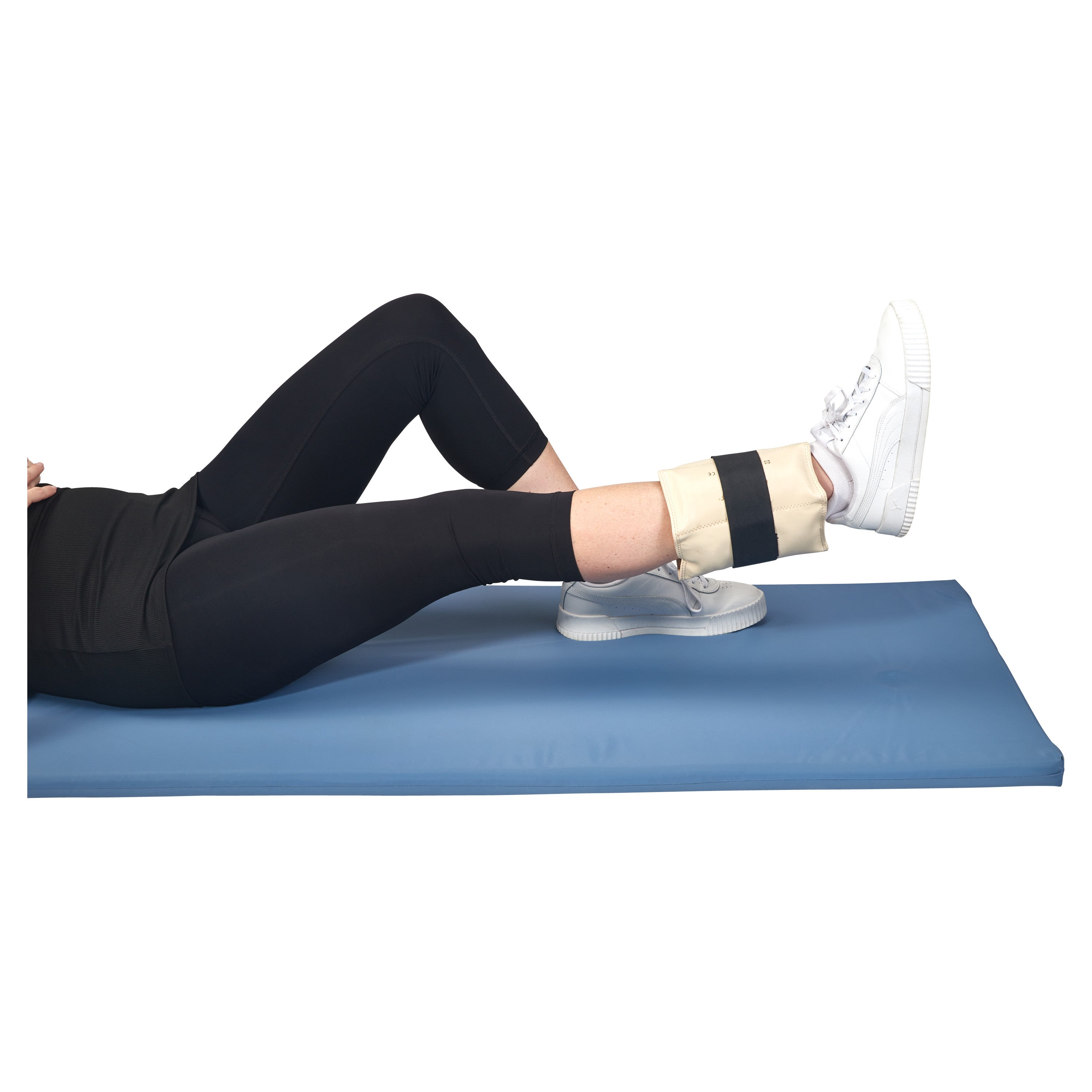 A person exercises on a blue mat wearing an AliMed Color-Coded Cuff Weight on their ankle, with white sneakers and black leggings.