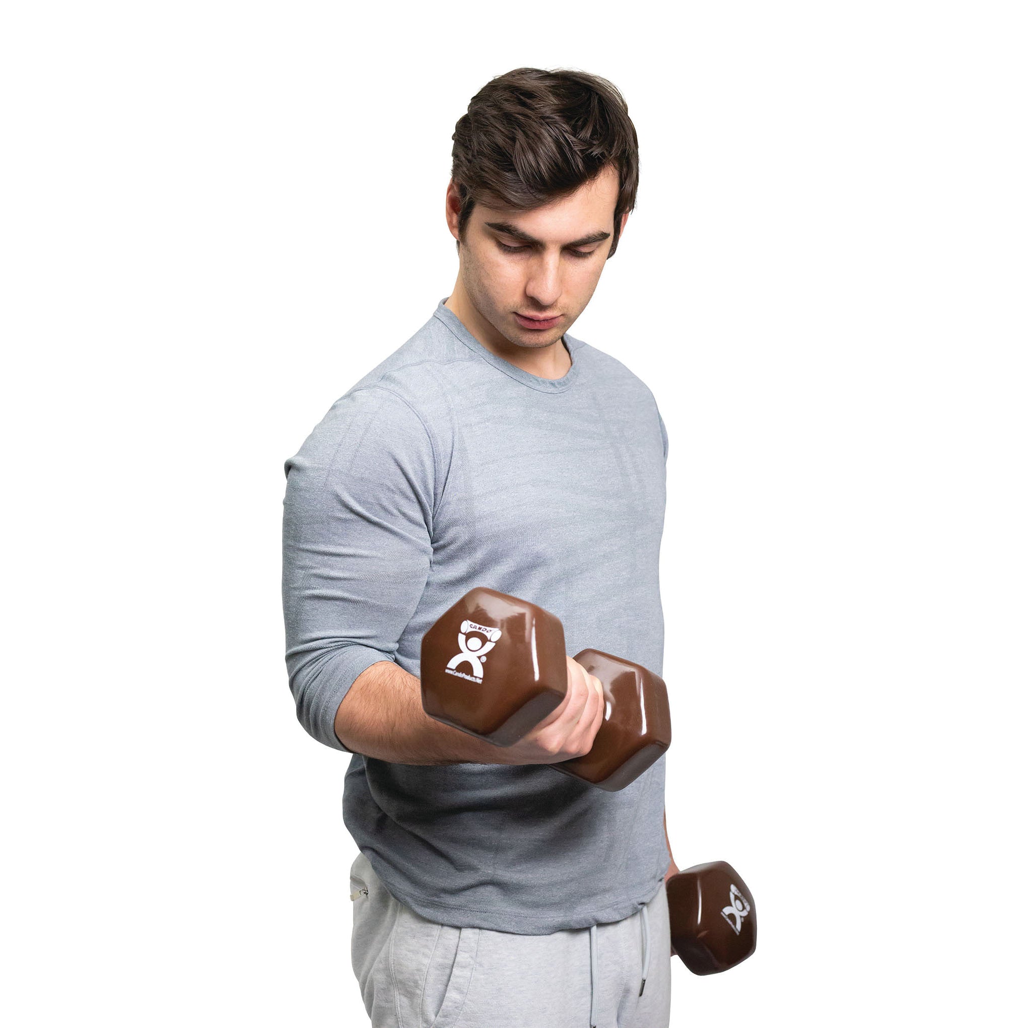 A person uses a CanDo Vinyl-Coated Dumbbell, brown, with a logo. They're wearing a gray shirt and light pants.