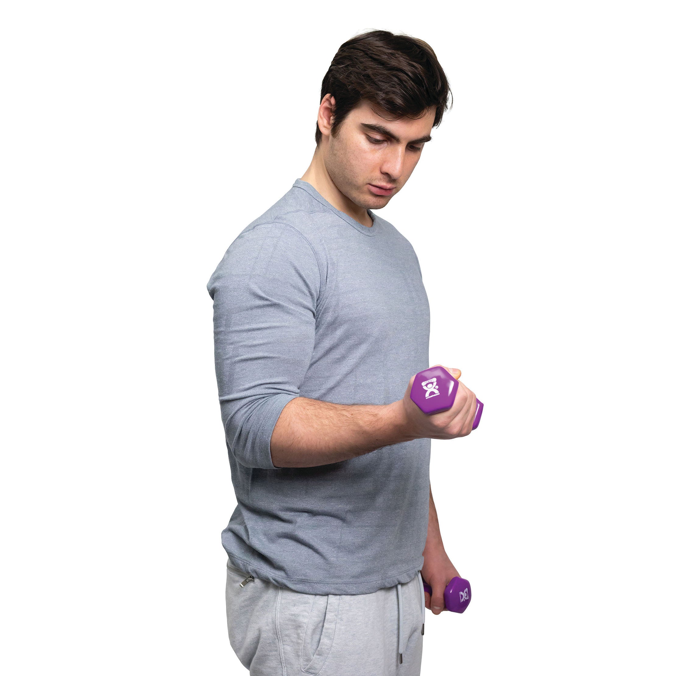 A person exercises with a purple CanDo Vinyl-Coated Dumbbell, wearing a gray shirt and pants against a white background.