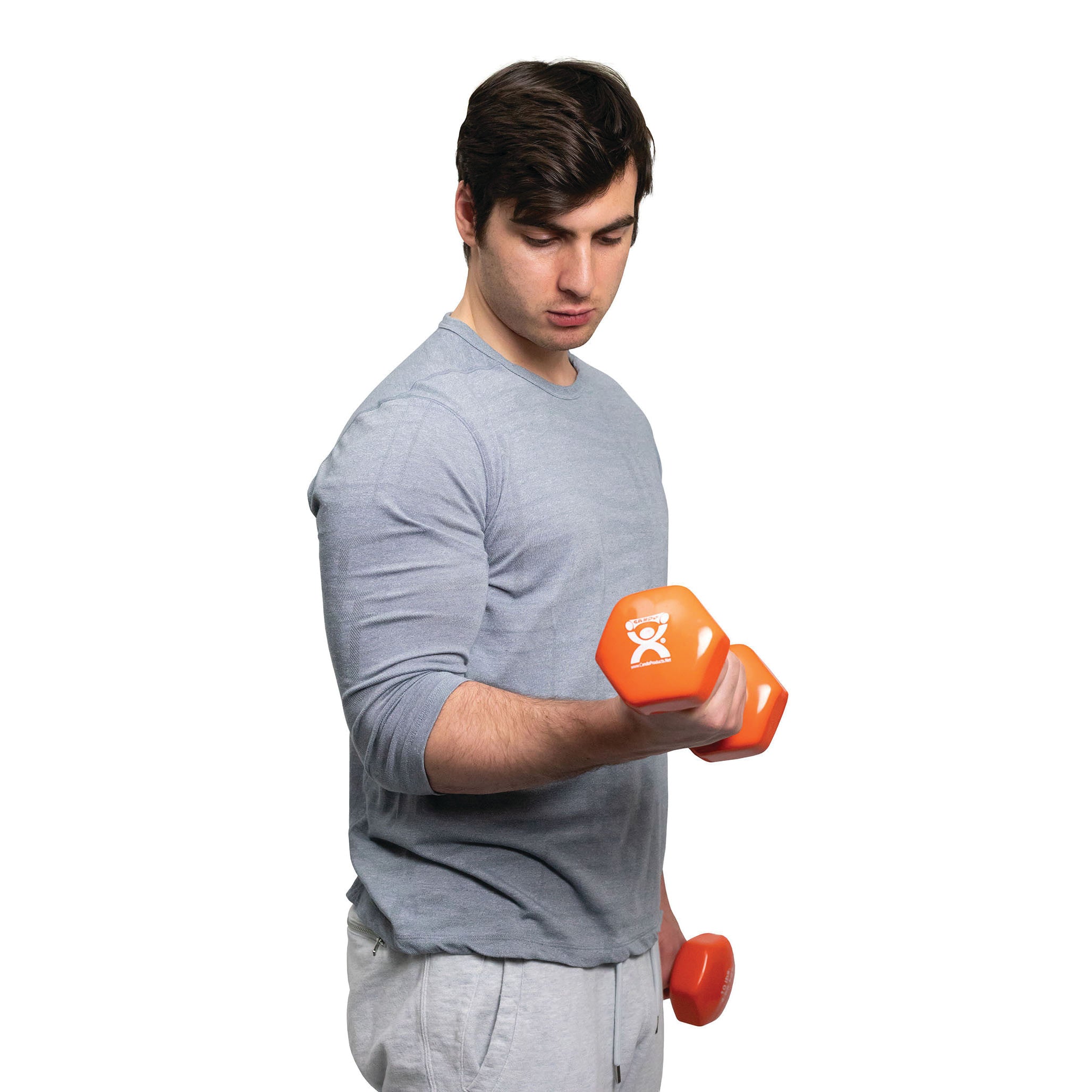 A person lifts an orange CanDo Vinyl-Coated Dumbbell, wearing a gray long-sleeve shirt and gray pants, on a white background.
