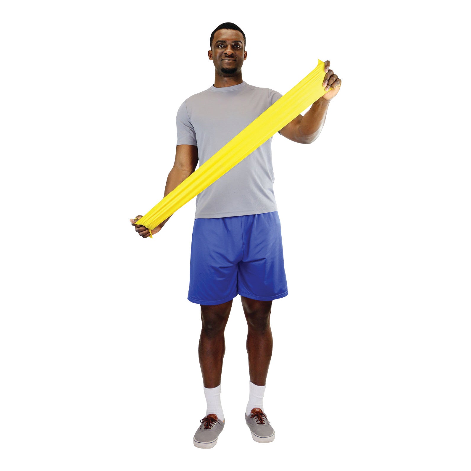 Man stretching a yellow CanDo Latex Exercise Band, wearing a gray shirt and blue shorts, on a white background.
