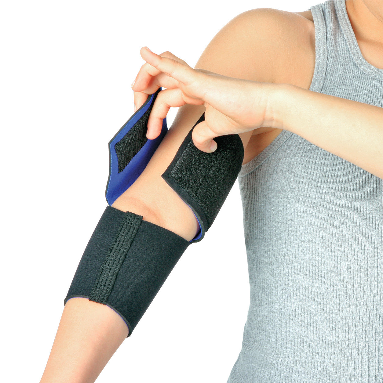 Person adjusting an AliMed FREEDOM Pediatric Elbow Sleeve on their arm. The sleeve is black with hook-and-loop fasteners.