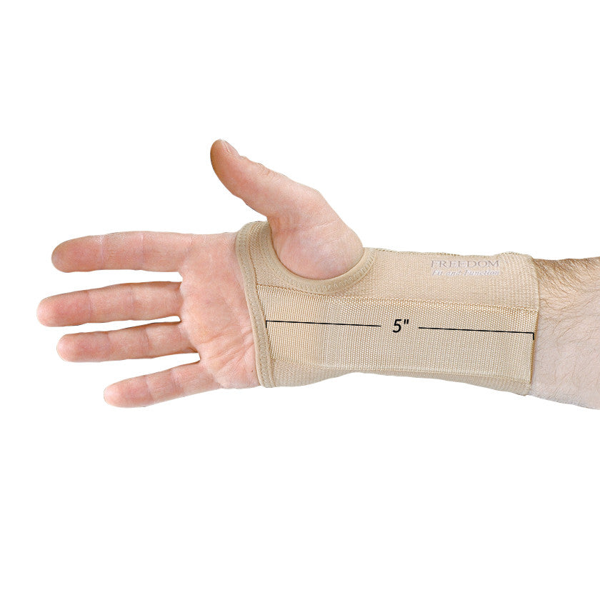 A hand wearing an AliMed FREEDOM Short Elastic Wrist Support, beige, measuring 5 inches in length, with an exposed thumb.