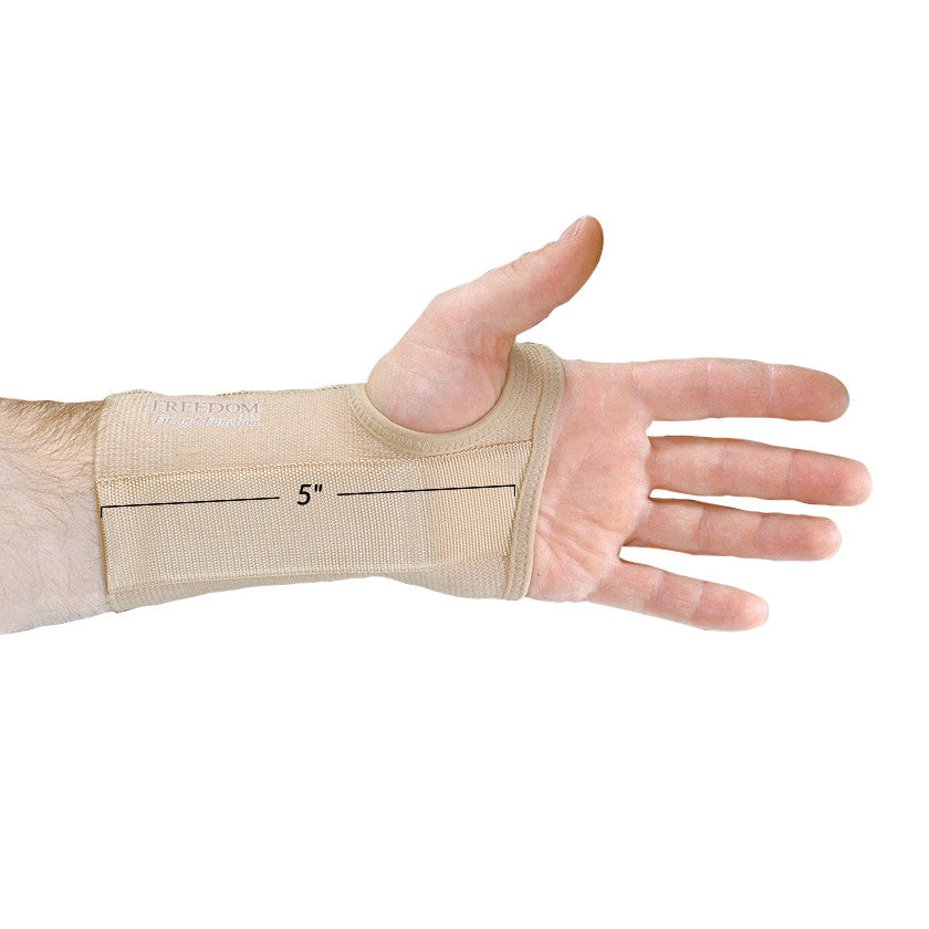 A hand wearing the AliMed FREEDOM Short Elastic Wrist Support, beige color, with a 5-inch measurement shown on the wrist brace.