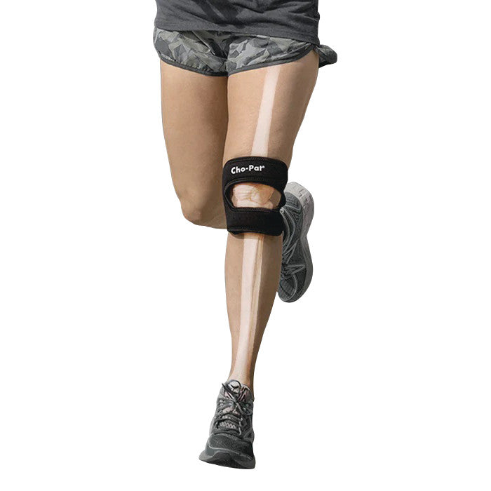 A person wearing a Cho-Pat Dual-Action Knee Strap while running, with a skeletal overlay on the leg.