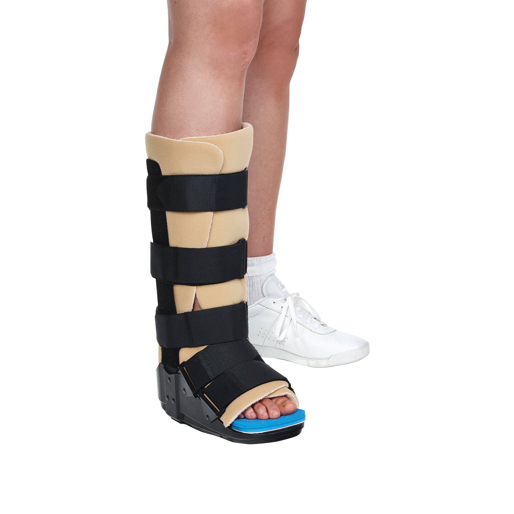 Person wears an AliMed Achilles Tendon Walker boot on one leg. The boot is beige with black straps and has an exposed toe section.
