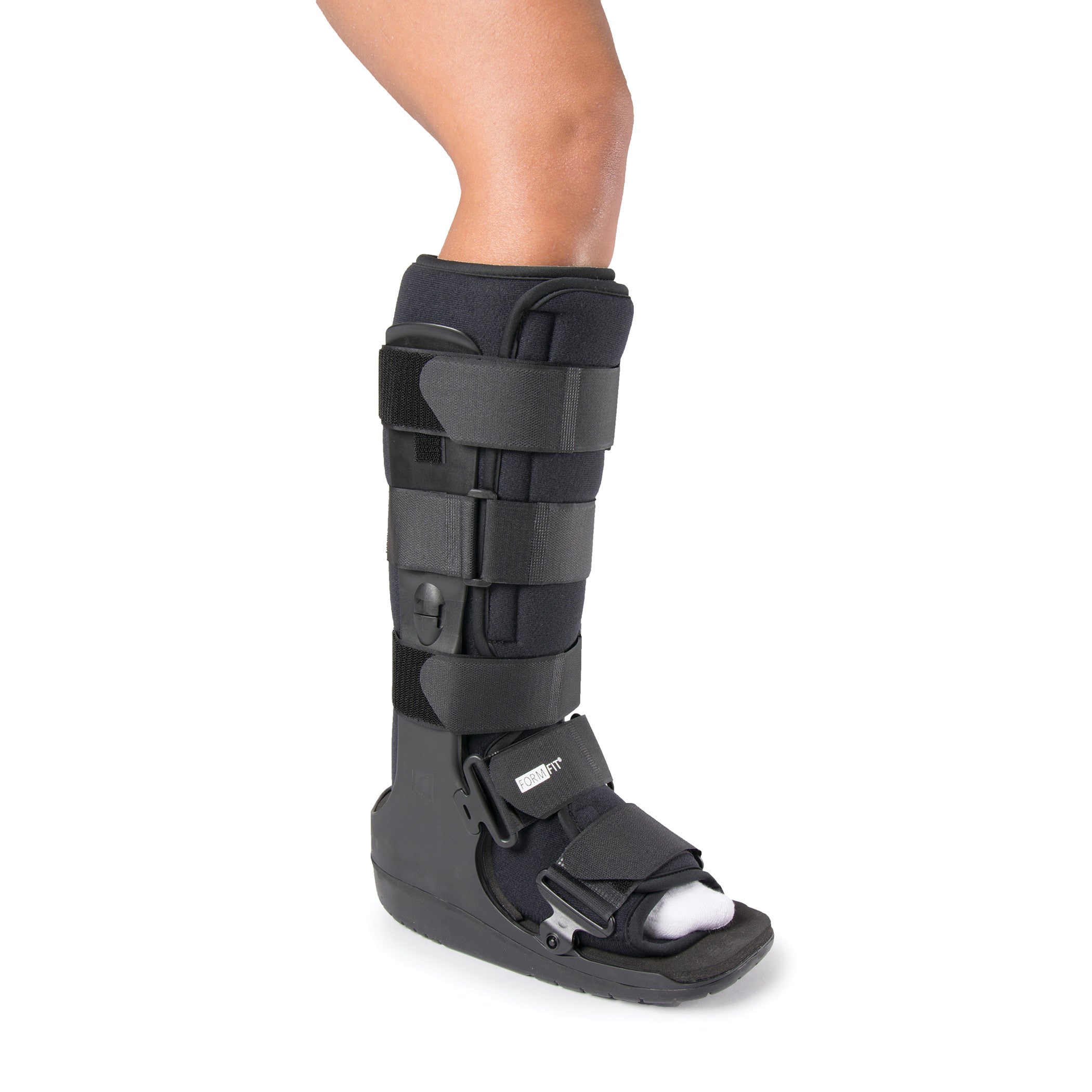 A leg in a black Ossur Formfit High-Top Walker with adjustable straps and open-toe design.