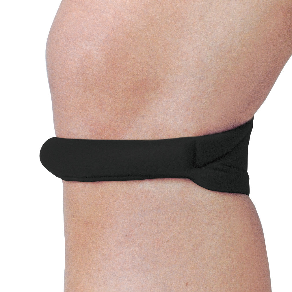 A Cho-Pat Knee Strap in black is wrapped around a person's knee, providing support and compression.