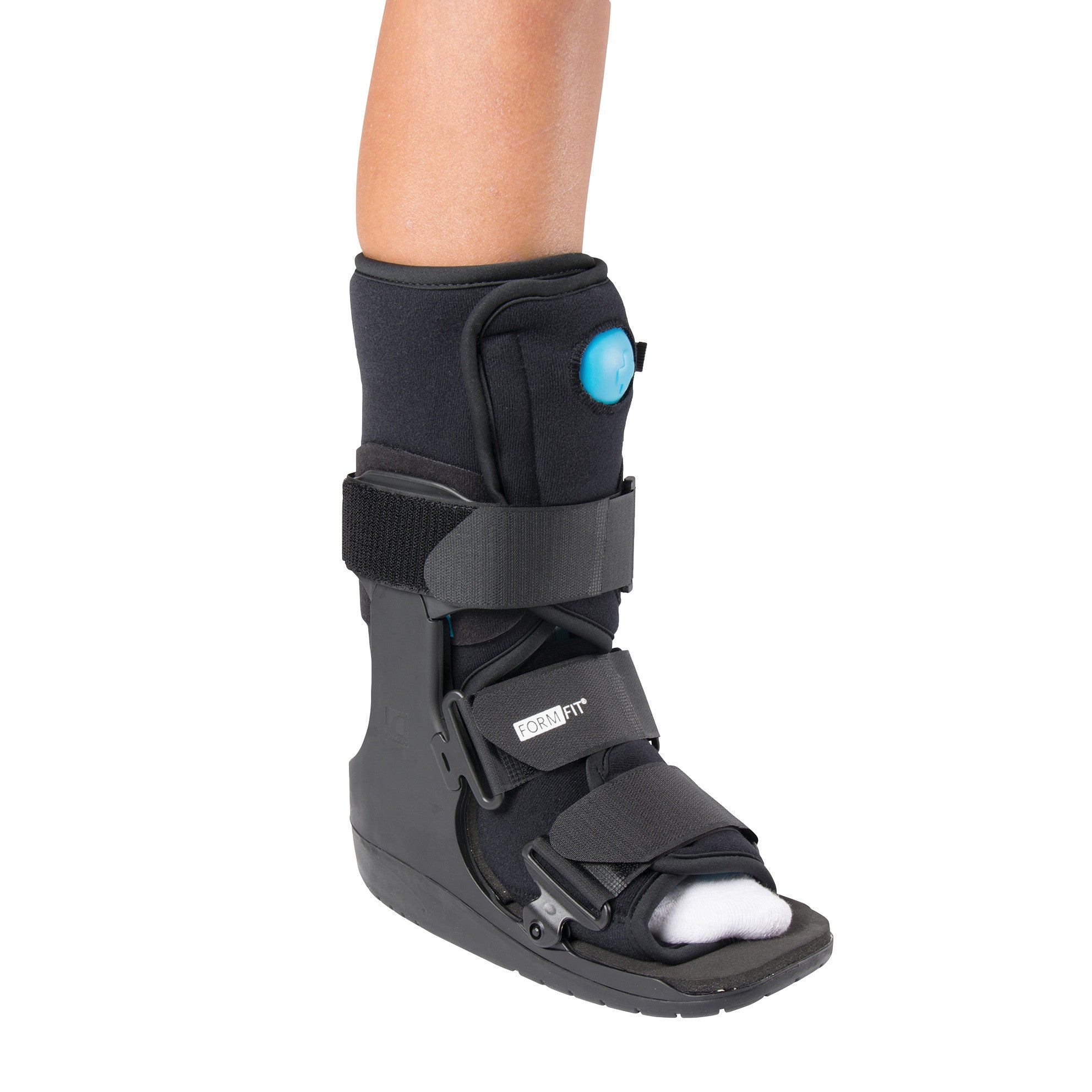 A leg wearing an Ossur Formfit Low-Top Air Walker, featuring multiple straps and a padded interior for support and stability.