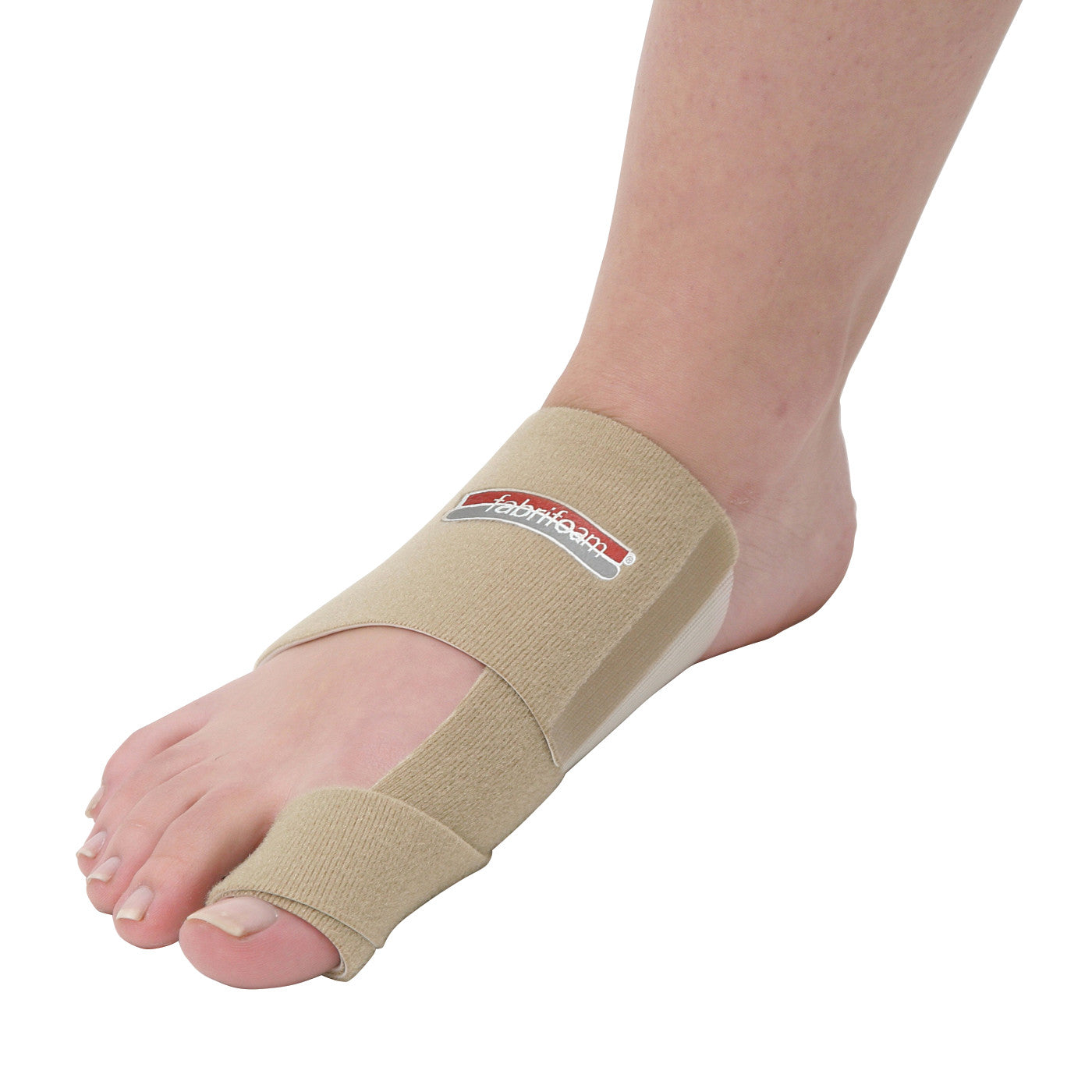 A foot wearing a beige Bunion Sling, wrapping around the big toe and midfoot. The fabric has a brand logo on it.