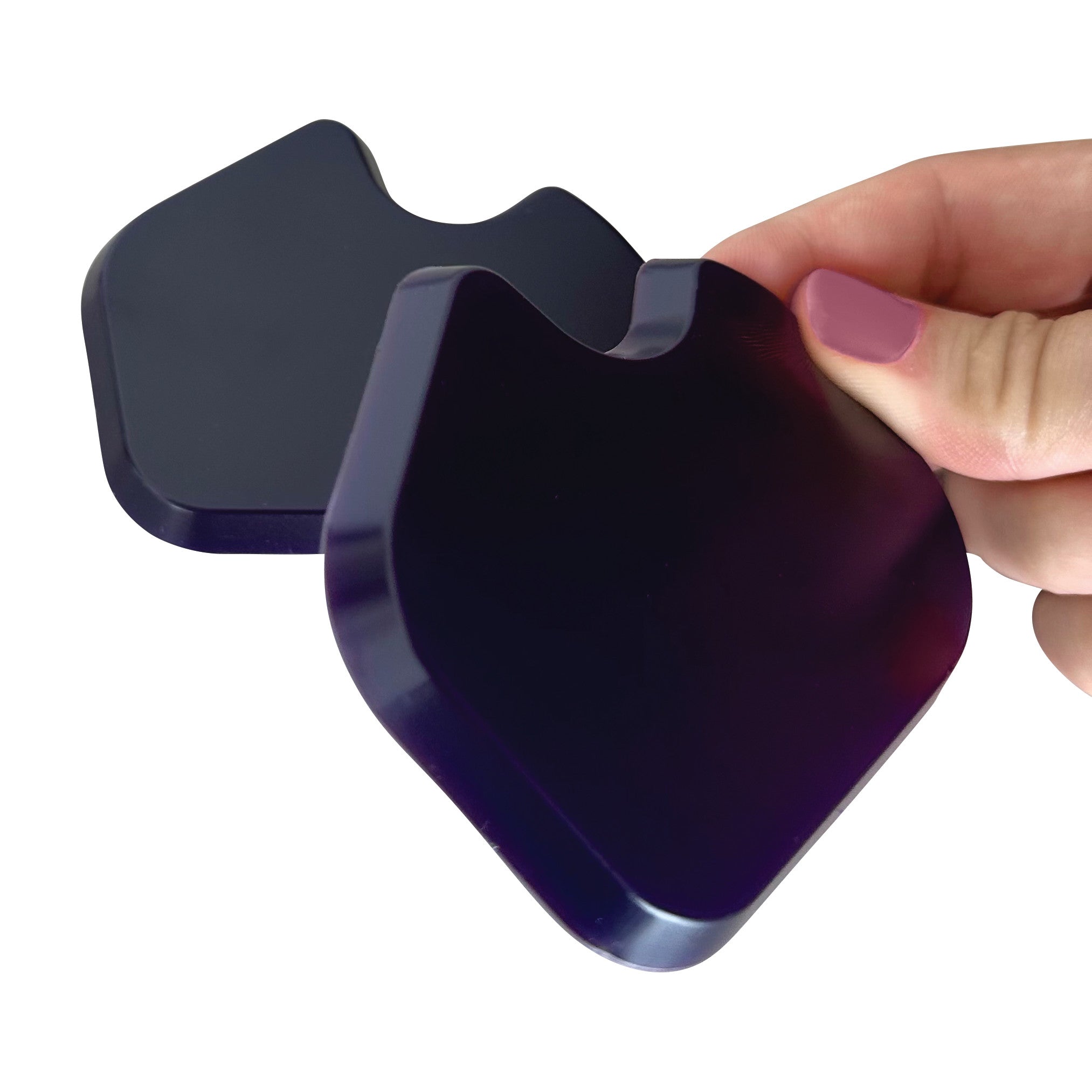Hand holding a black Gel Dancer Met Pad, showcasing its smooth, curved shape, with another pad in the background.