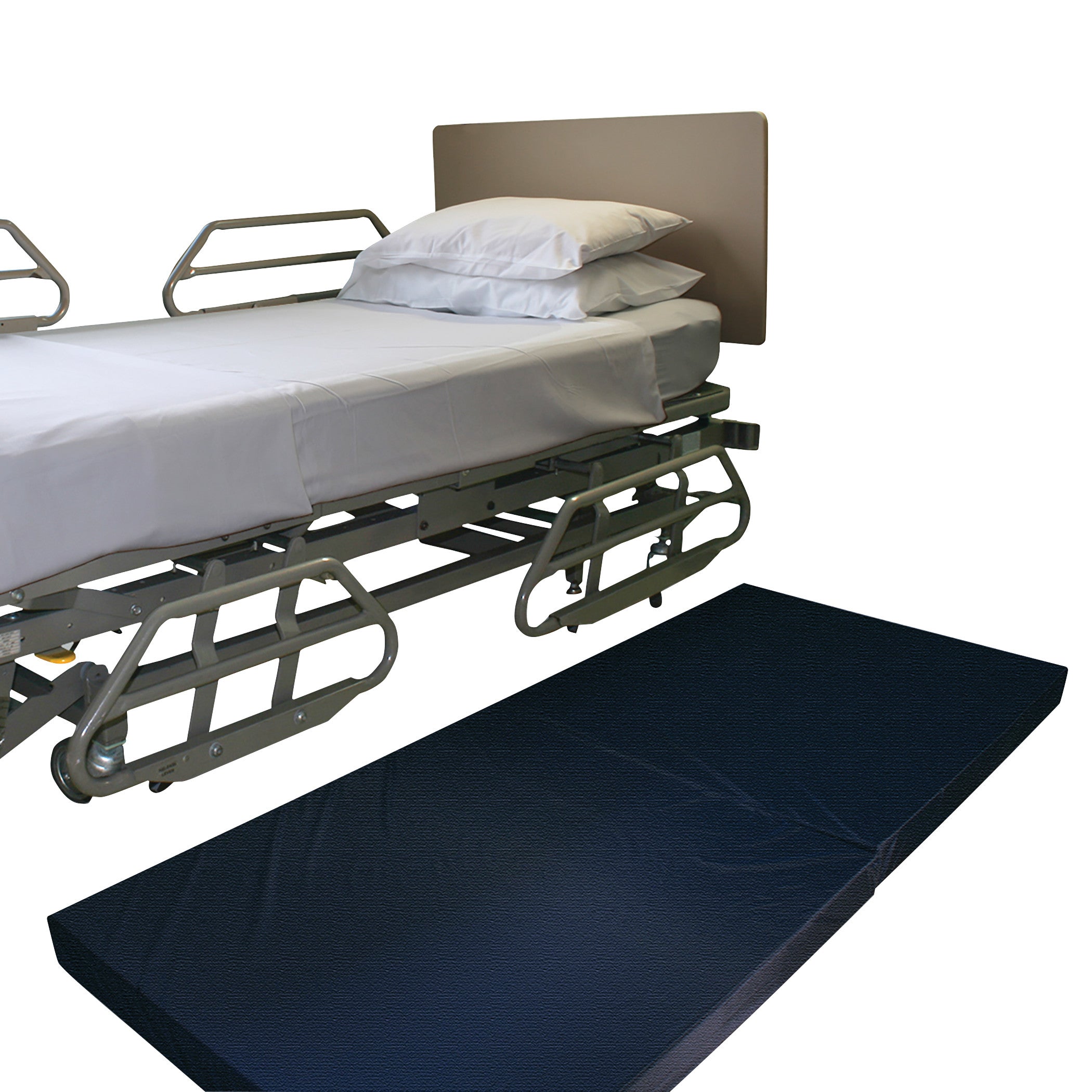 A hospital bed with rails and white bedding next to a black NYOrtho Bedside Safety Mat on the floor.