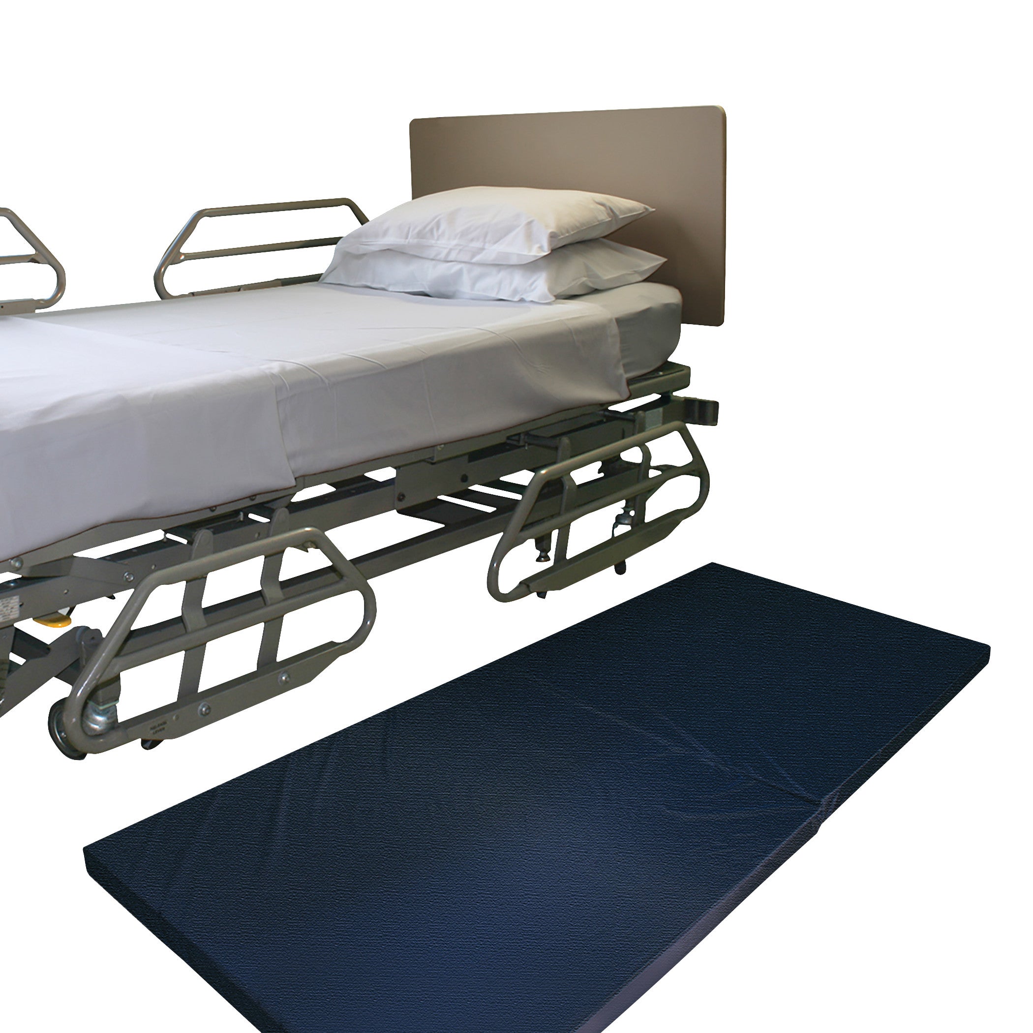 A hospital bed with side rails and white bedding is shown with a NYOrtho Bedside Safety Mat placed on the floor beside it.