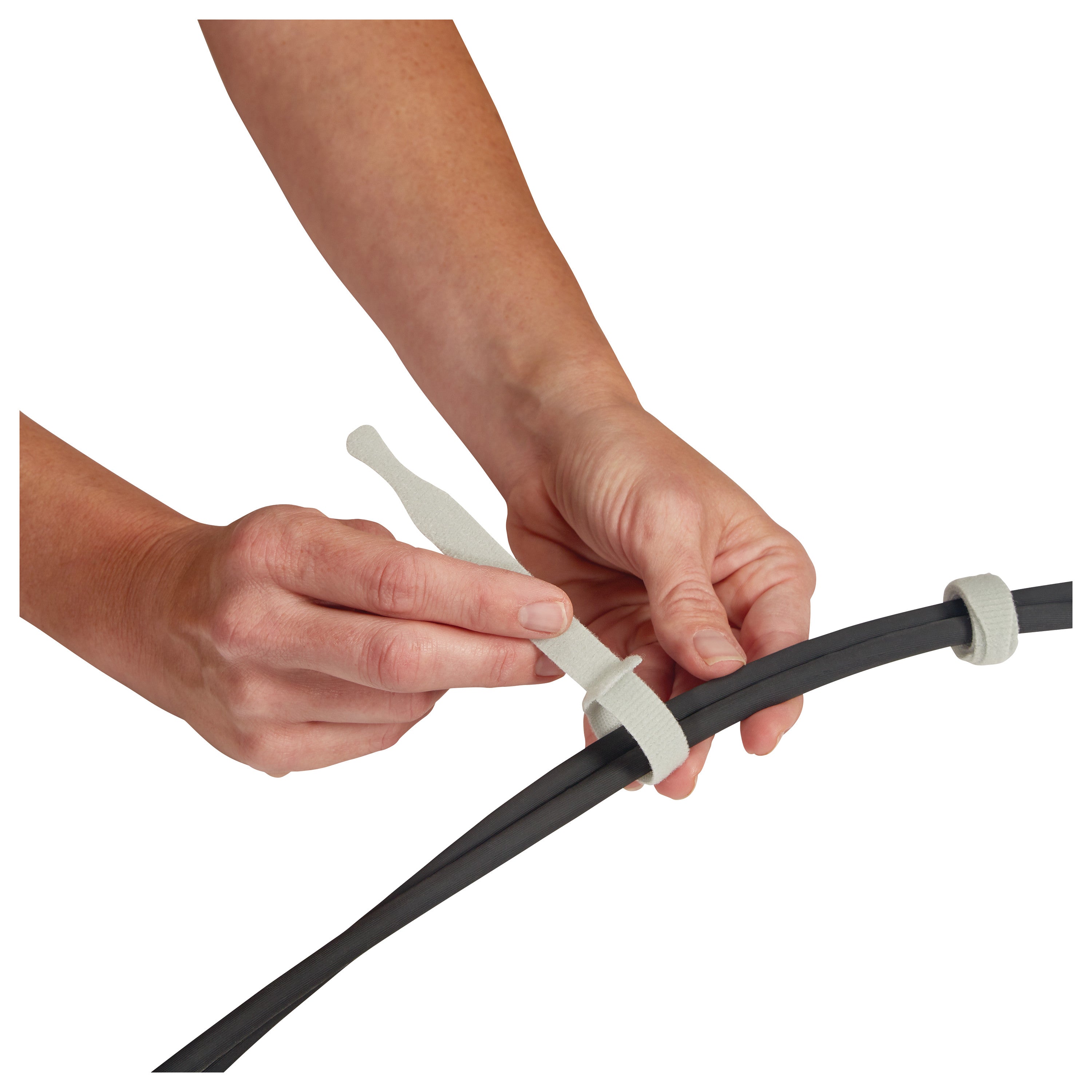 Hands fasten wires with AliMed AliTies, flexible, reusable strap ties.