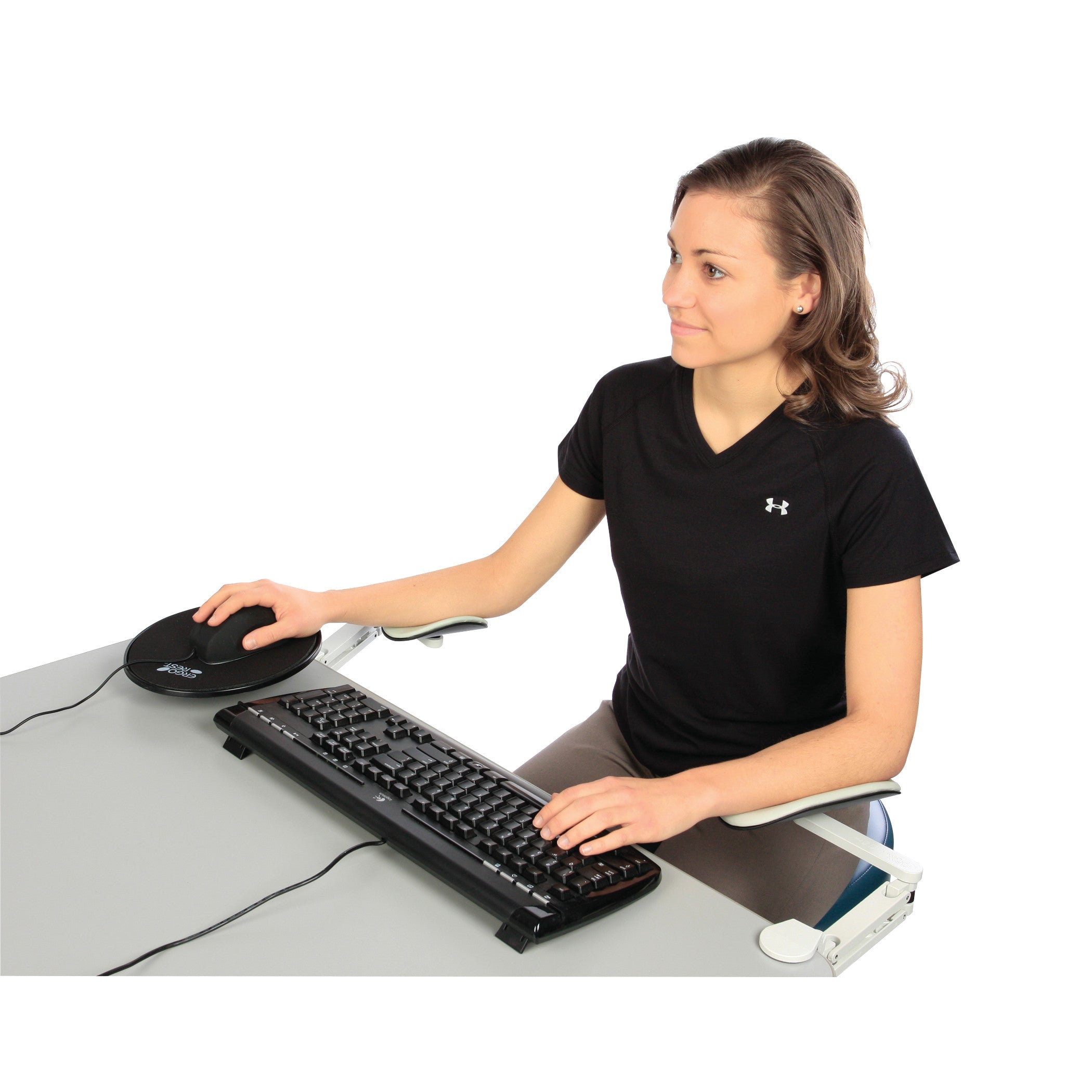 A person uses a computer with the ErgoRest Articulating Forearm Support, which is attached to the desk, under their forearm.