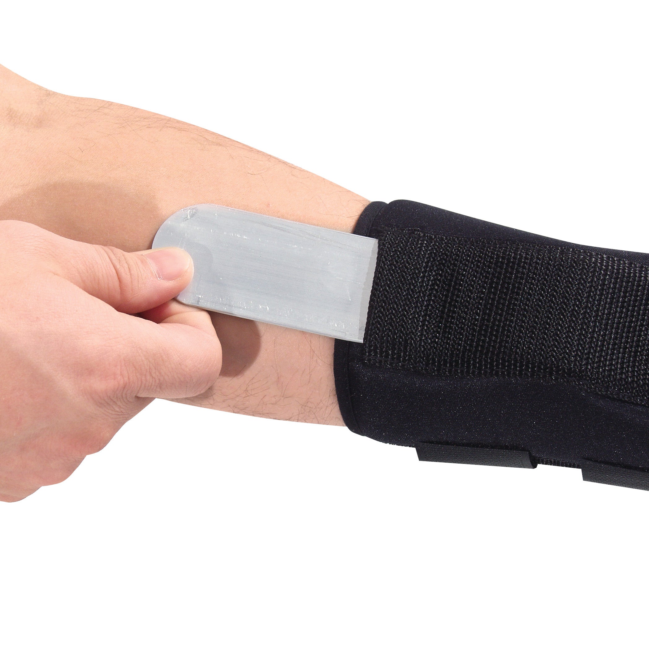 A hand adjusts the AliMed FREEDOM Comfort Thumb Spica brace on a forearm. The brace is black with a metal support insert.
