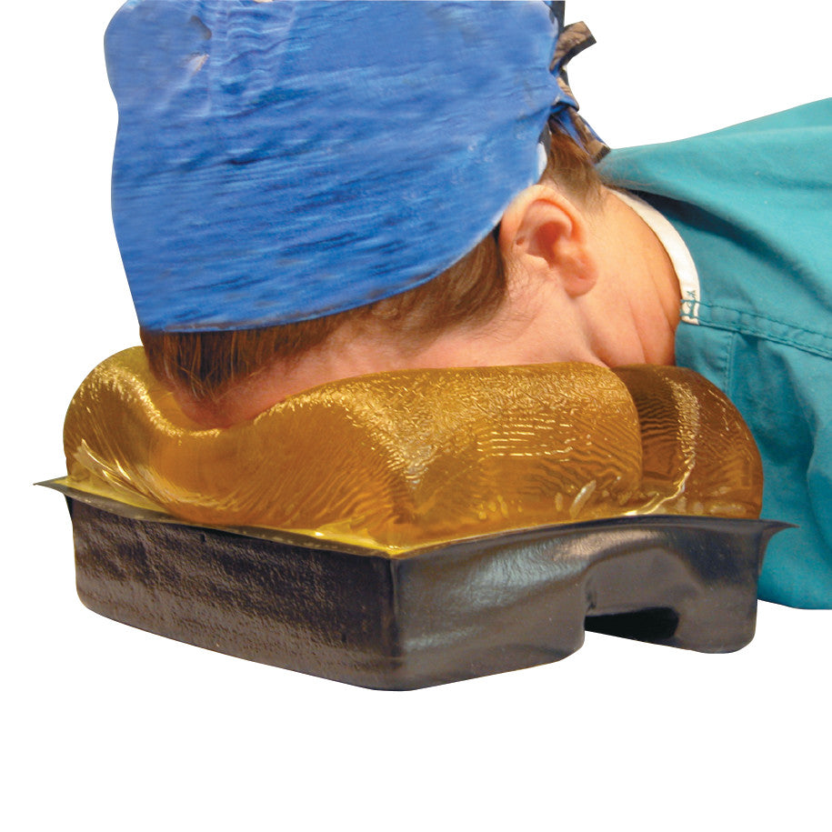 A person rests their face on the AliMed AliGel Prone Head Pad, designed for comfort in a medical or therapeutic setting.