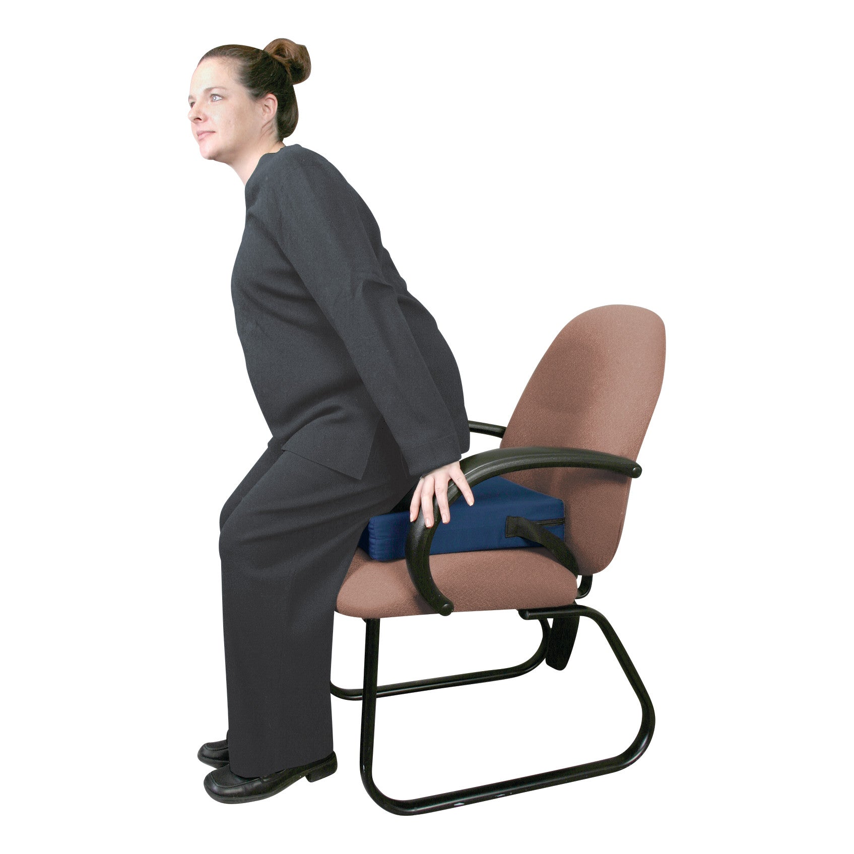 A woman demonstrates the AliMed Portable Easy Up Sit-to-Stand Cushion on a chair. She is in the process of standing up.