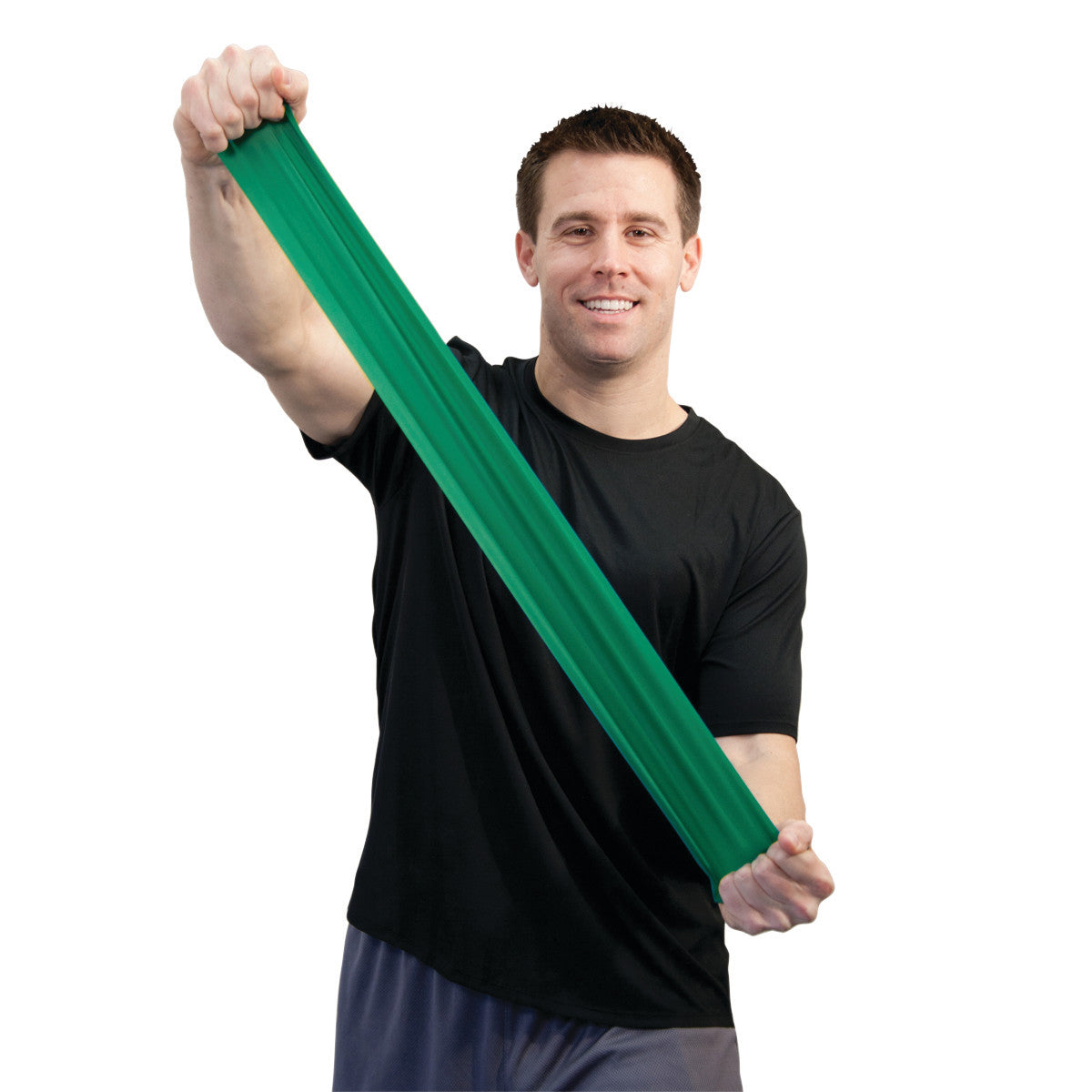 A person stretches a green CanDo Sup-R Band Non-Latex Exercise Band, wearing a black shirt and smiling.