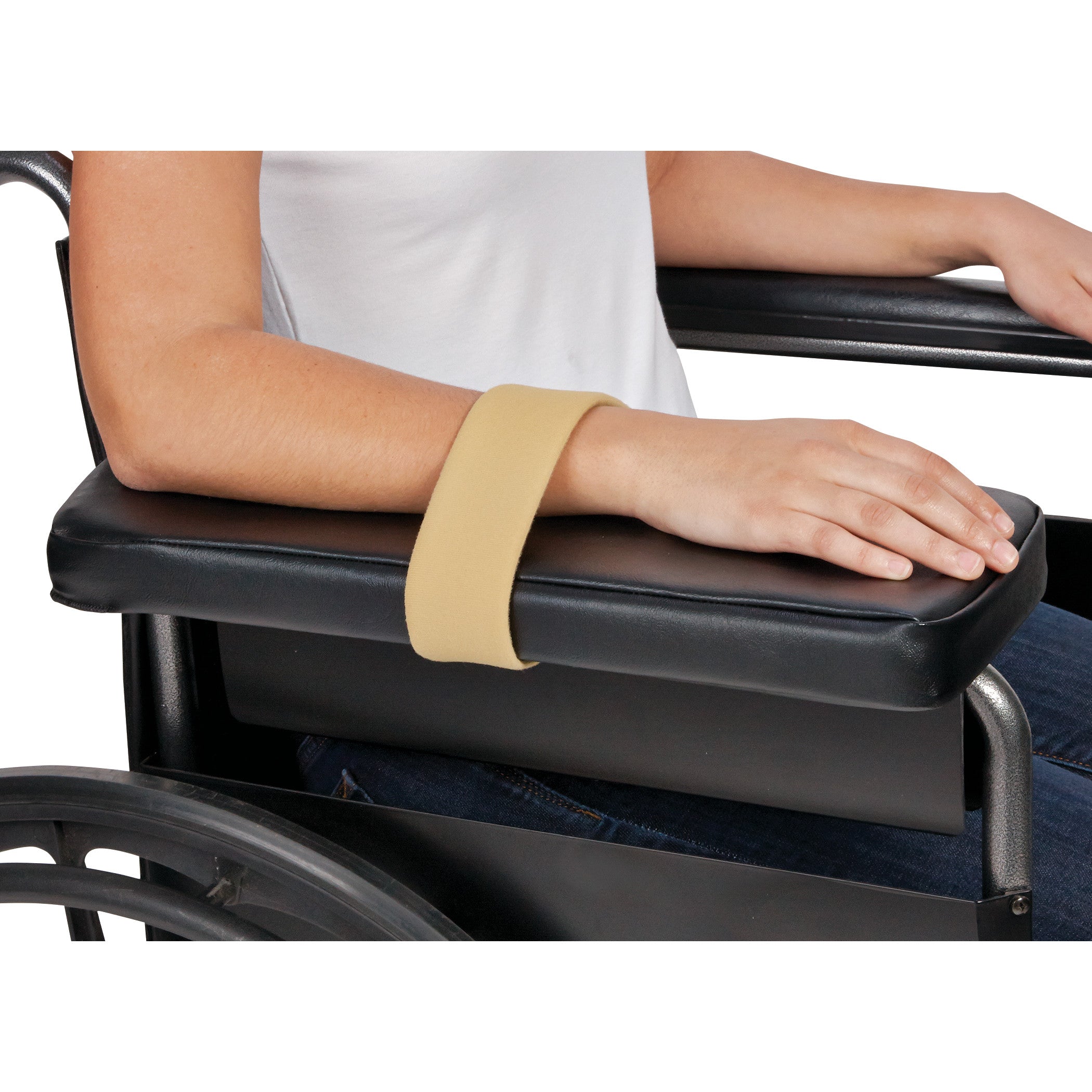 A person's forearm is secured with an AliMed Beta Pile II Loop on a black wheelchair armrest, providing support and stability.