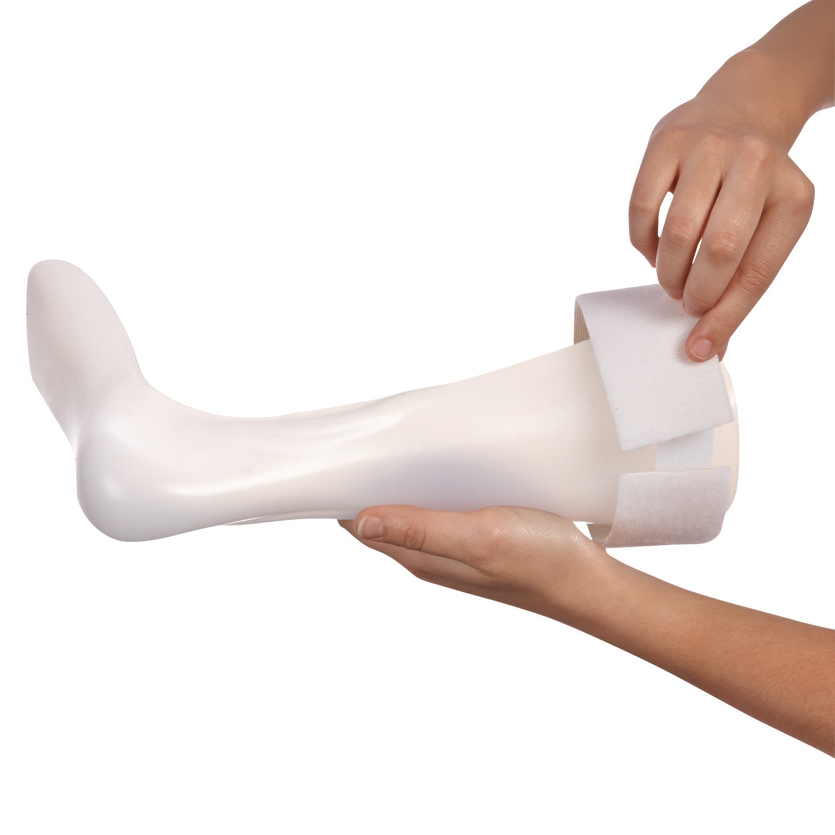 Hands hold a white prosthetic leg with an AliMed Beta Soft Strap Loop being adjusted around it.