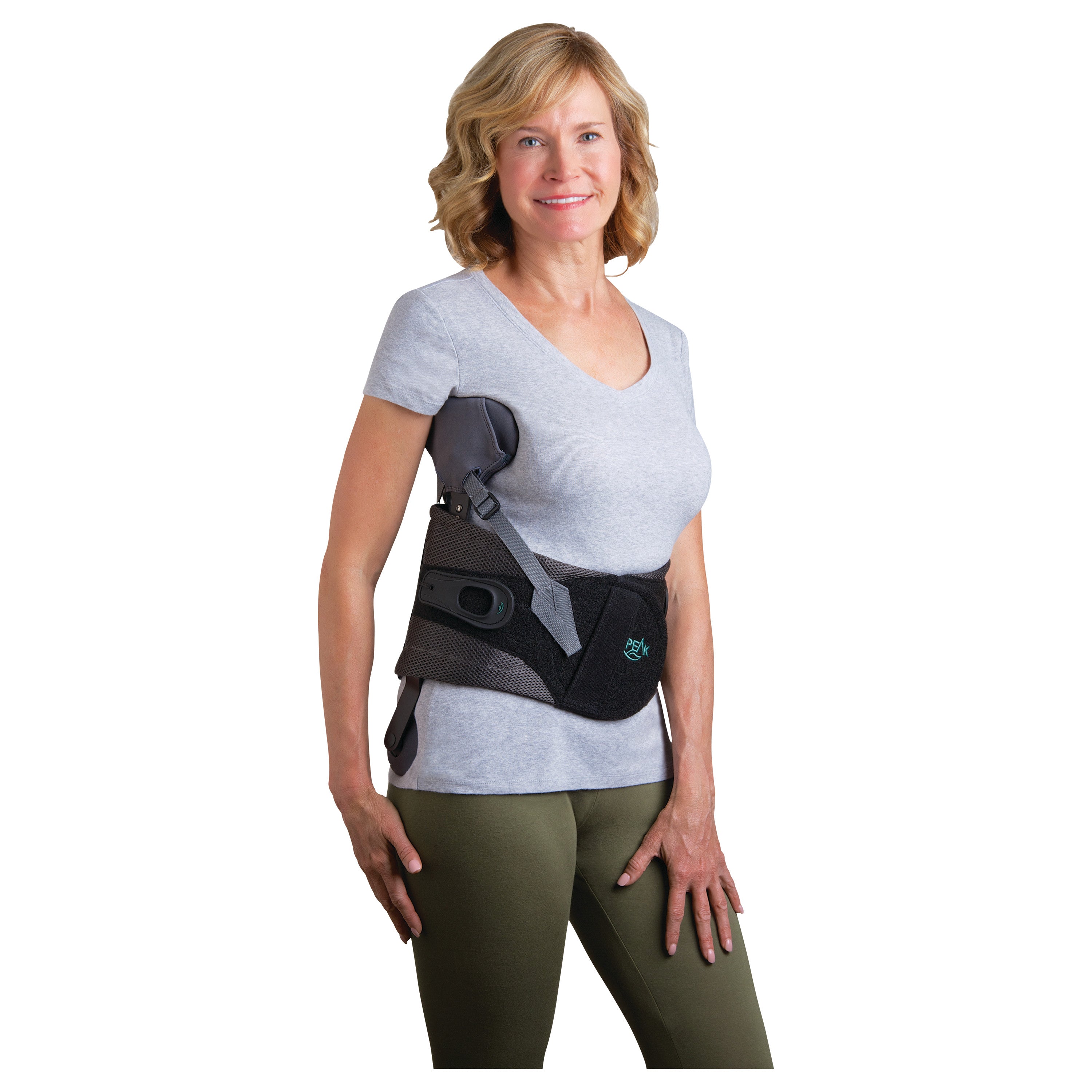 Woman wearing the Peak Scoliosis Bracing System, featuring a black support brace with adjustable straps over a gray T-shirt.