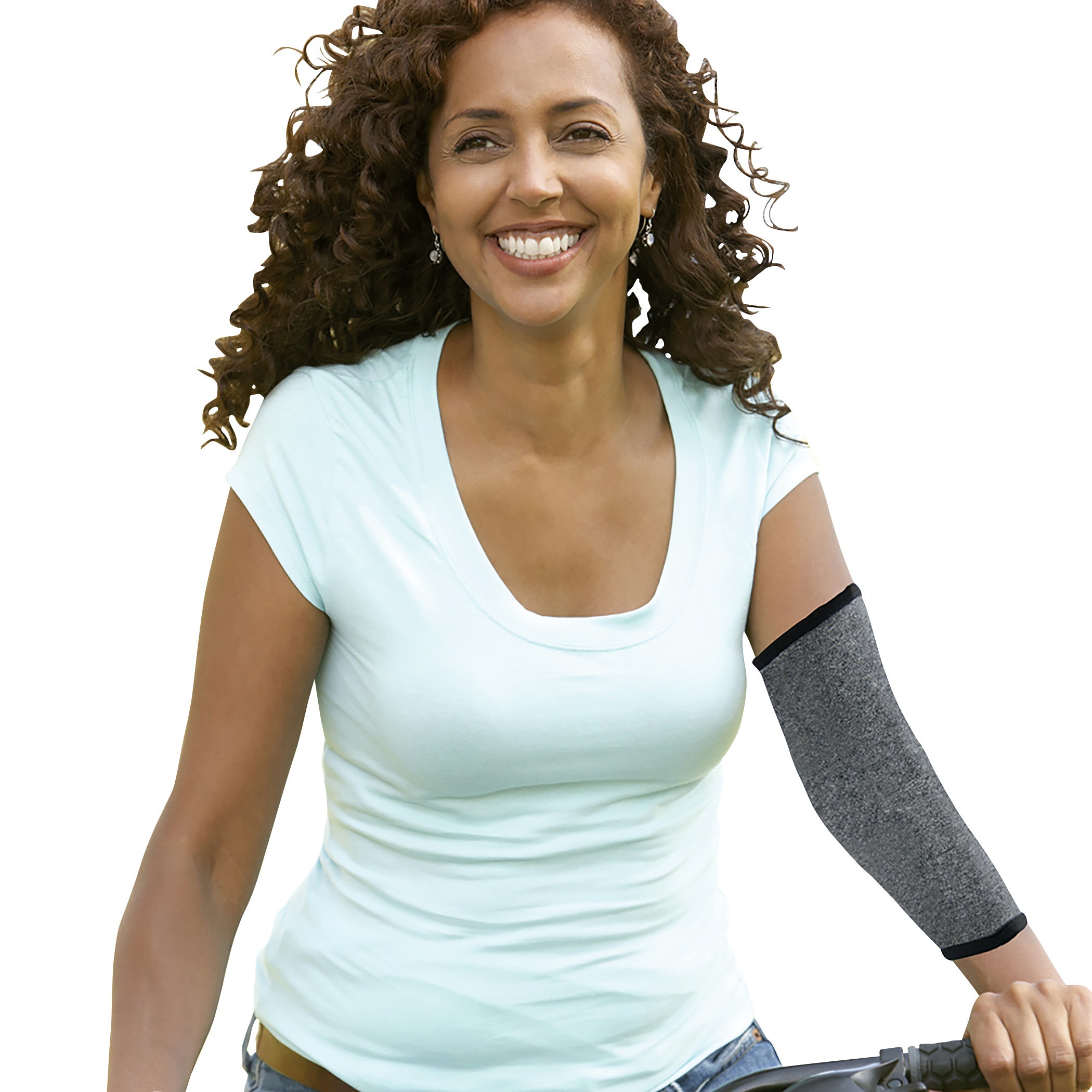 A smiling woman wears a Brownmed IMAK Compression Arthritis Elbow Sleeve on her right arm, paired with a light blue t-shirt.